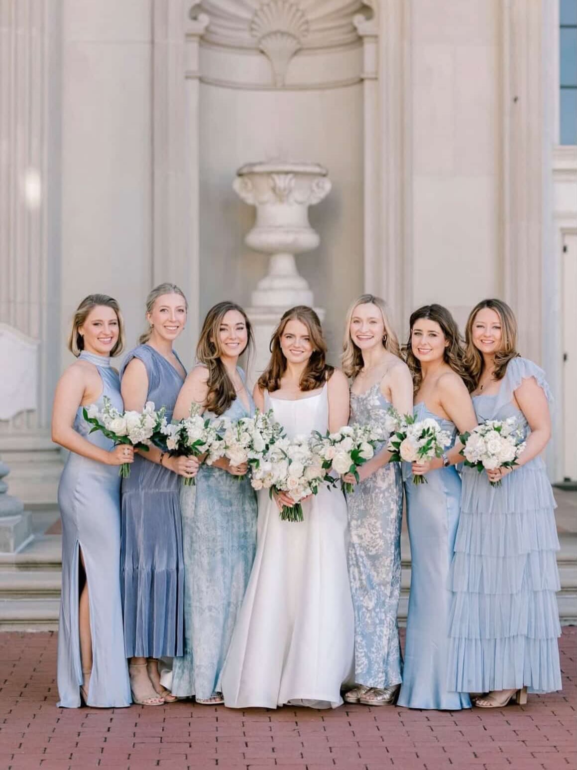 Bride @allisonainsworthjohns really showed us that #icyblue isn&rsquo;t just for winter. 

Her chosen blue color palette for her mismatched bridesmaids dresses proved that trendy can still be timeless. 

Gown: The Cady from @warrenbarronbridal 
Photo