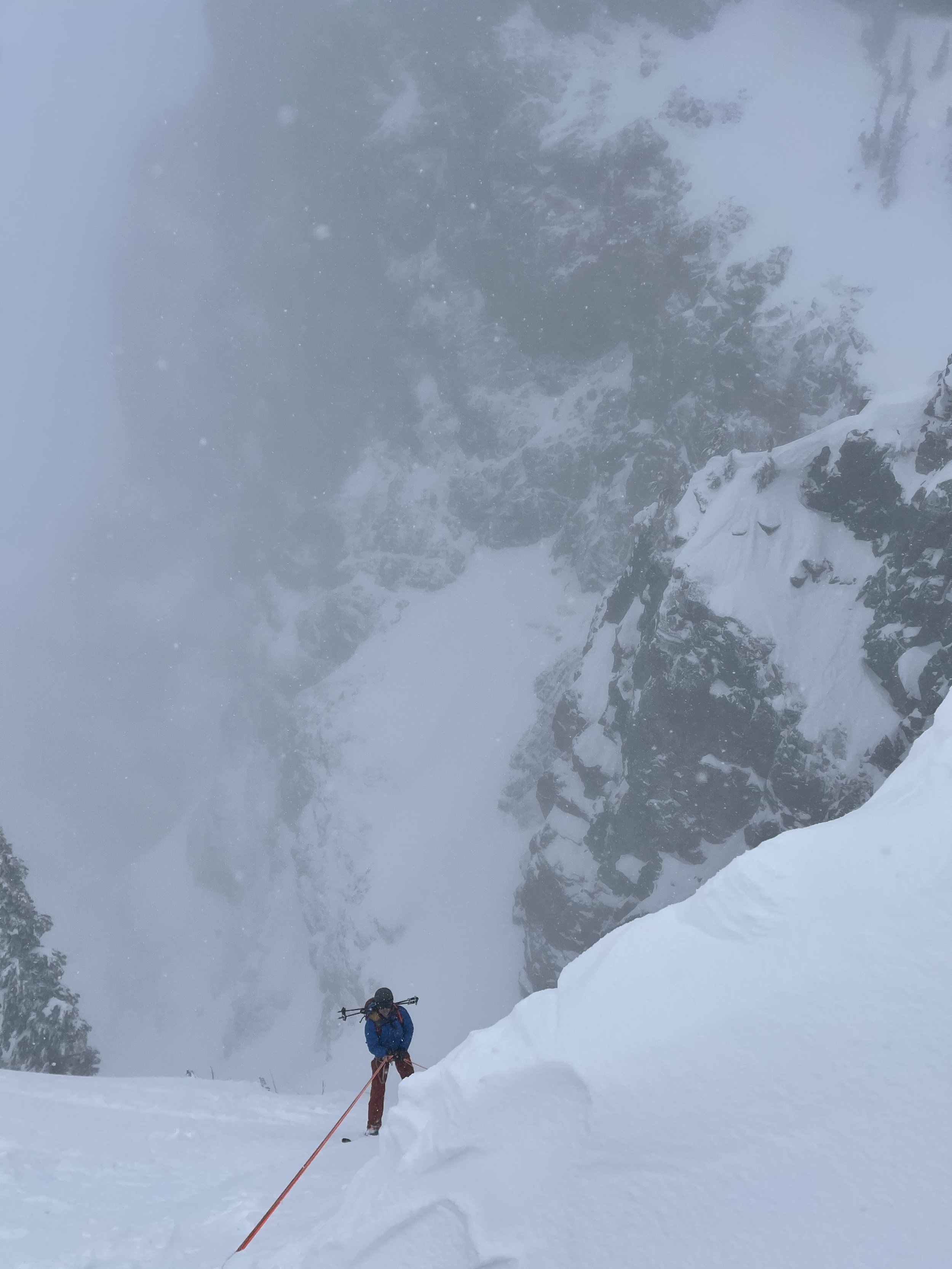 Looking down at the rap while Rappelling into the Snot Couloir on Mt. Snoqualmie, in the Snoqualmie Pass Backcountry. This Tour requires a 50+ meter rappel.