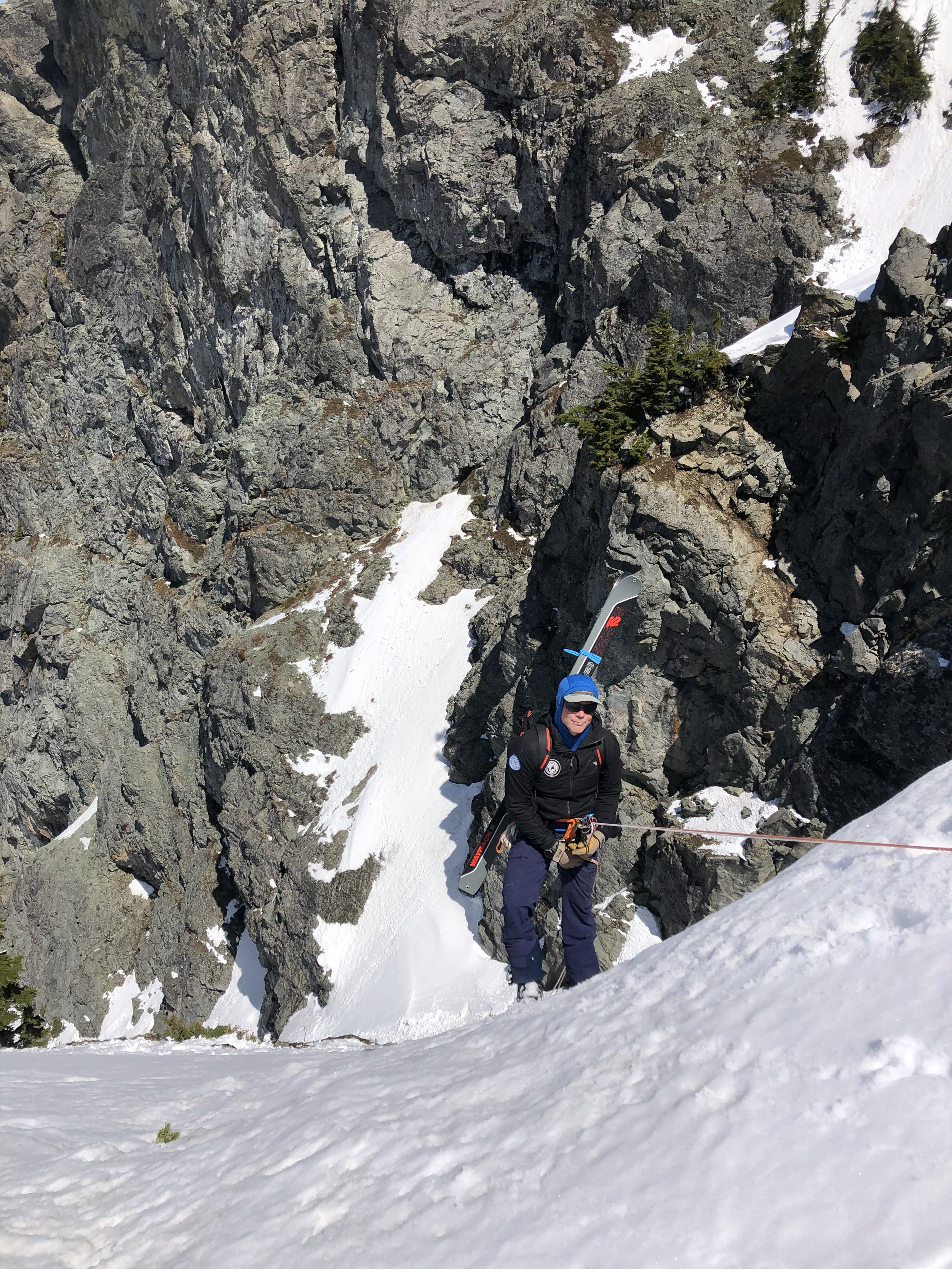 Ian Nicholson rappelling into the Snot Couloir on Snoqualmie Mountain in the Snoqualmie Pass backcountry.
