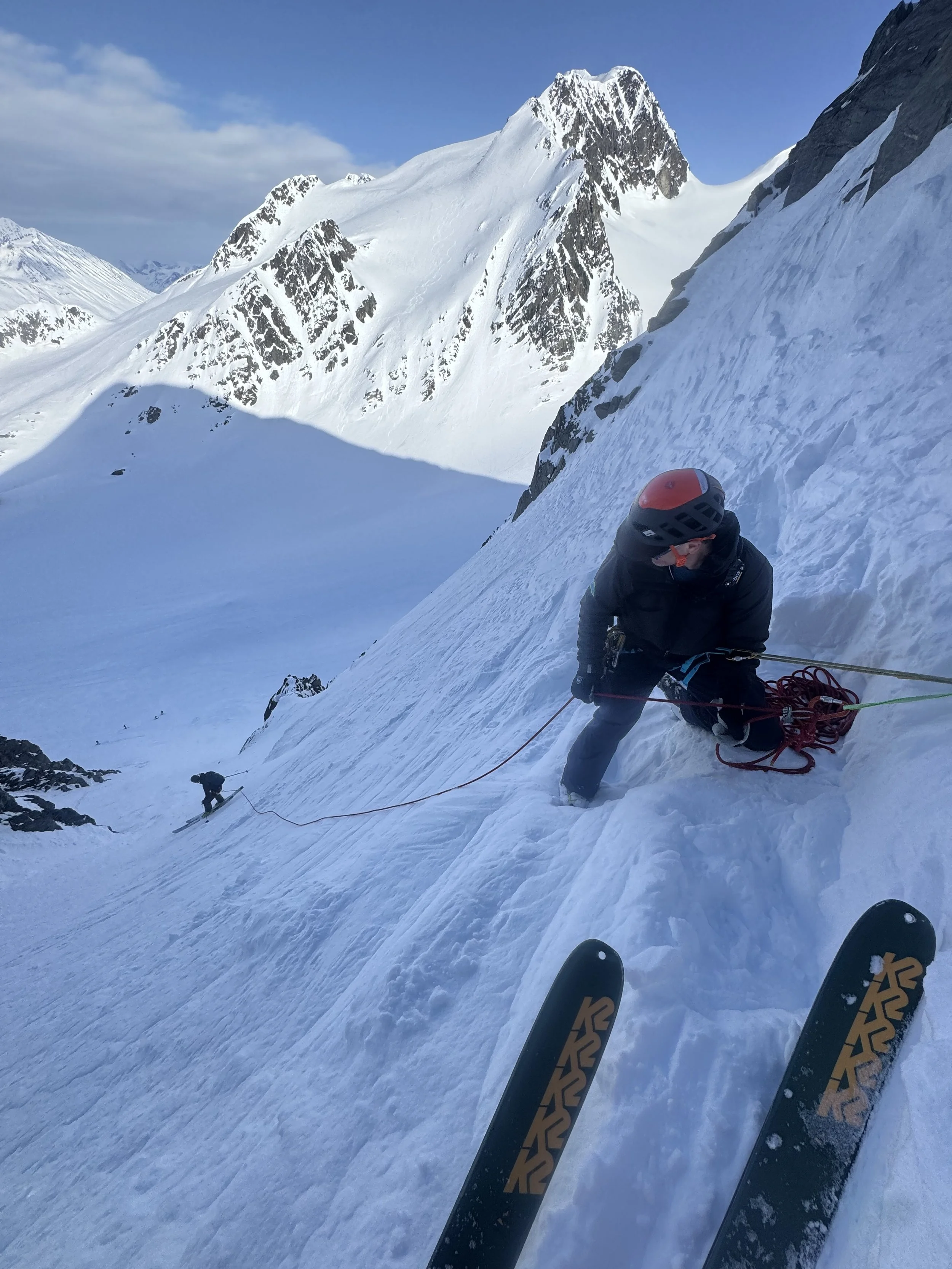 Arthur Baines belaying down the step and committing Cherry Couloir on the Python, while ski touring in the Chugach Mountains at Thompson Pass near Valdez, Alaska. Photo by Ian Nicholson