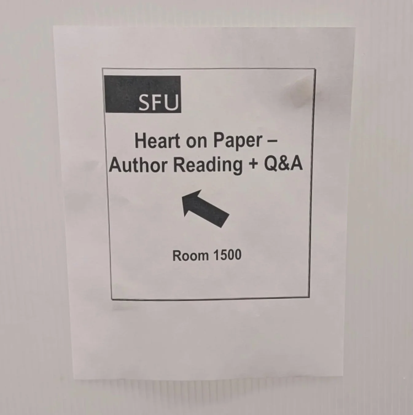Sign for SFU Heart on Paper - Author Reading and Q&A, pointing to Room 1500.