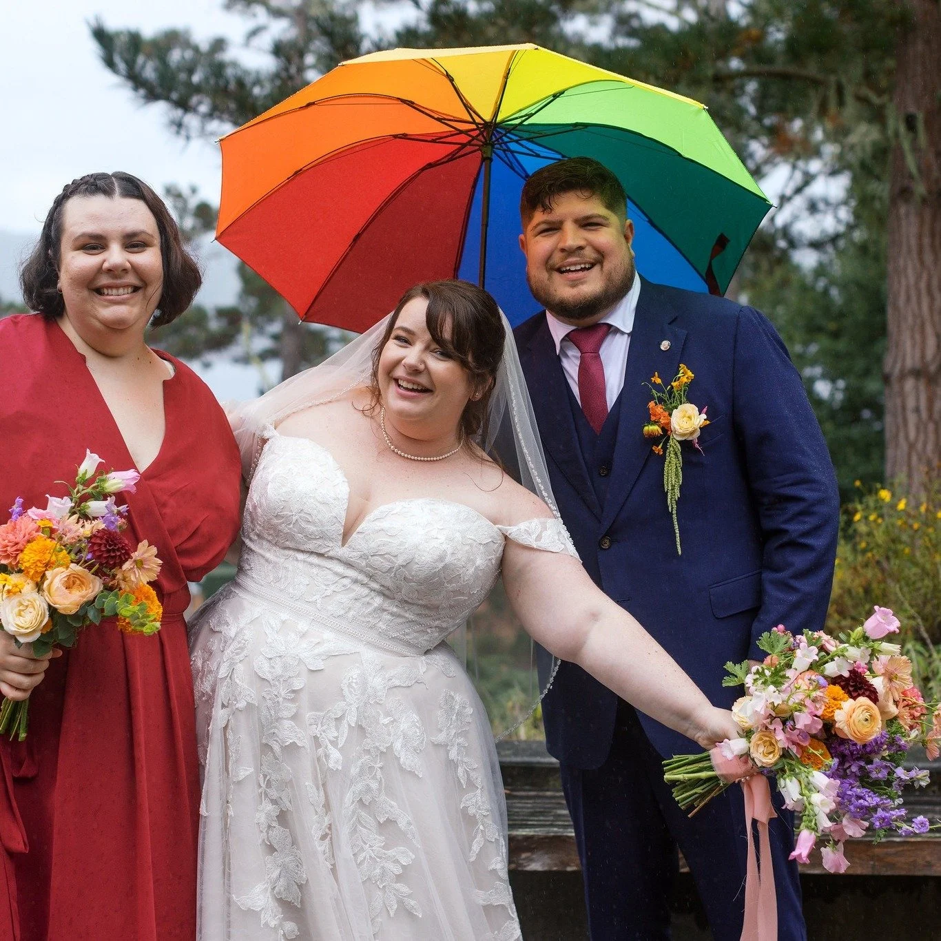 Rain on a wedding day&hellip; and not a single mood was dampened.

Out came the rainbow umbrellas, bright florals popped even more against the gray sky, and everywhere you looked were smiling faces, laughter, and people fully leaning into the moment.