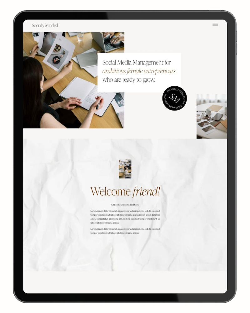 The tablet screen displays a website about social media management for ambitious female entrepreneurs, with images of people working on laptops and holding photographs, and welcoming text to visitors.