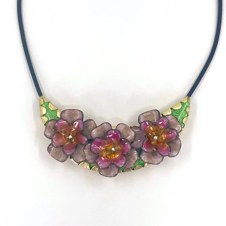 Crescent pendant with enamel pink roses and green background and brass setting