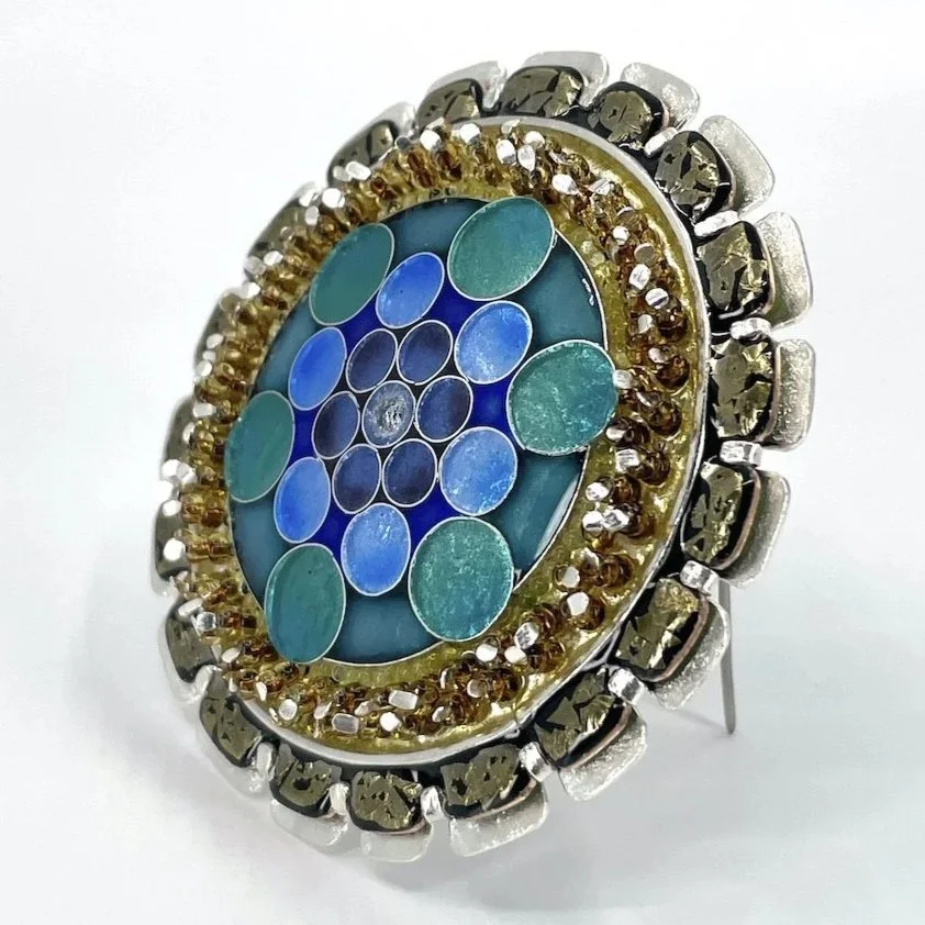 round handmade cloisonné  enamel brooch with blue and green circles and amber beads and silver setting