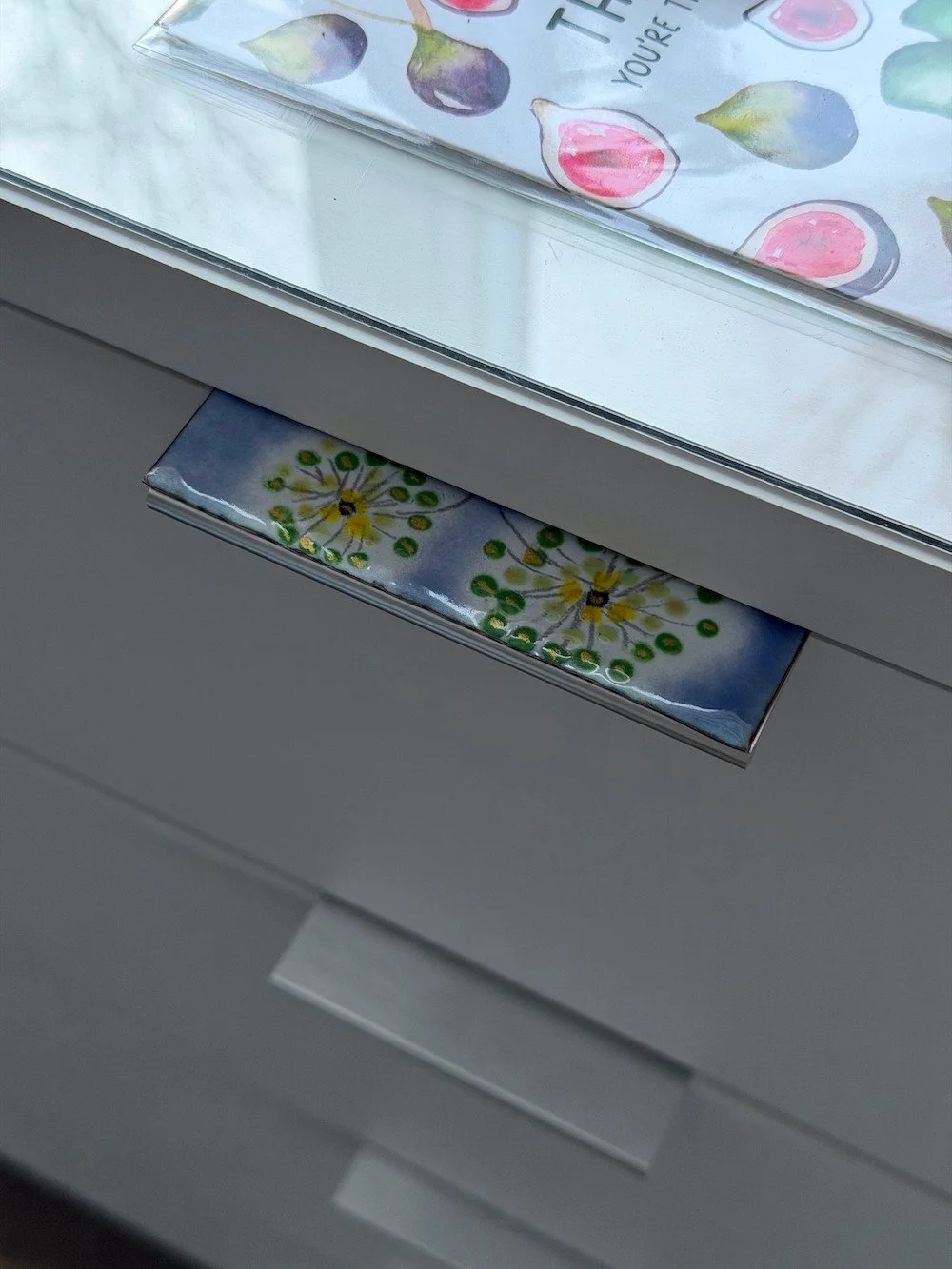 Drawer handle with enamel flowers and purple background