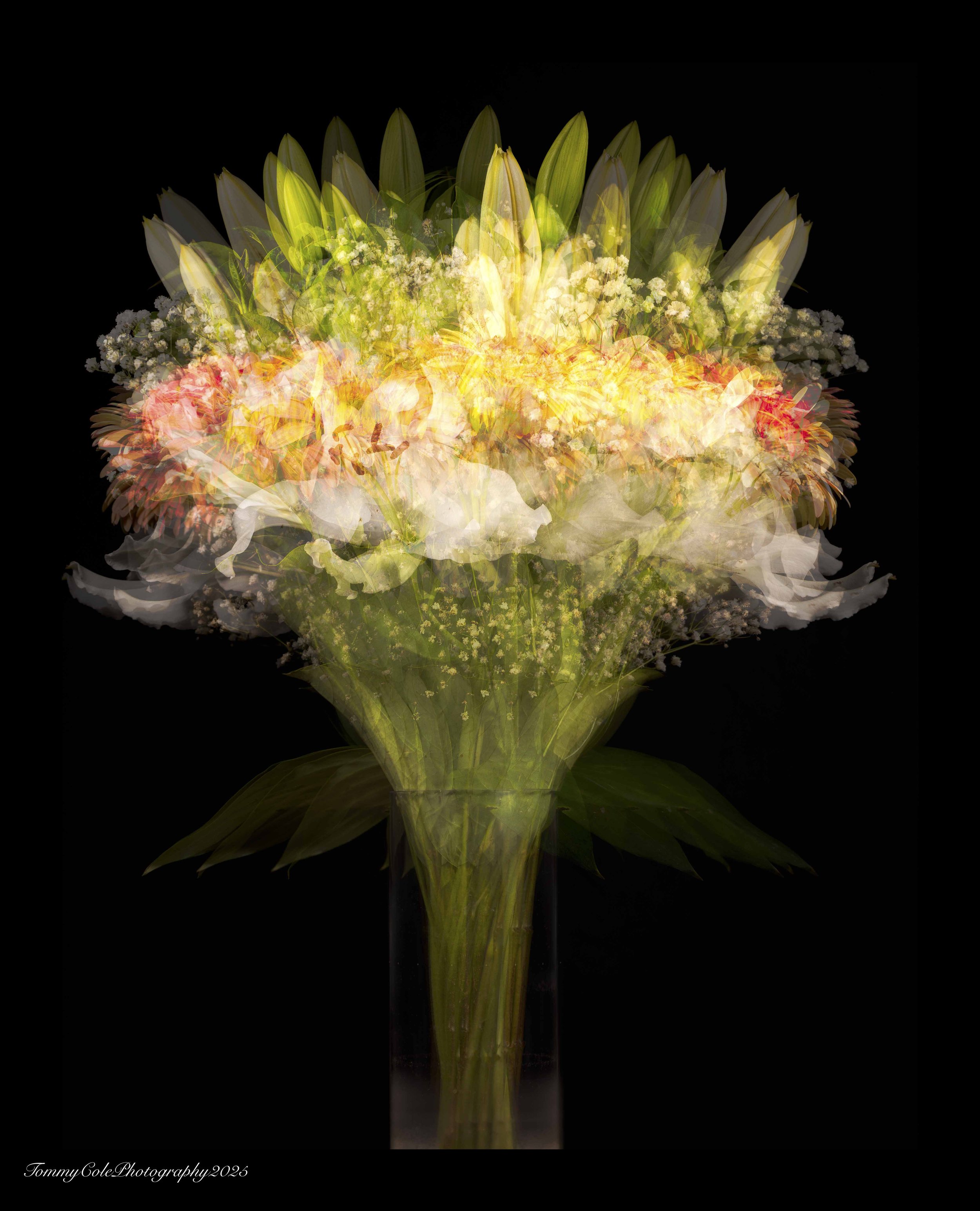A digitally layered bouquet of various flowers in a tall clear glass vase against a black background.