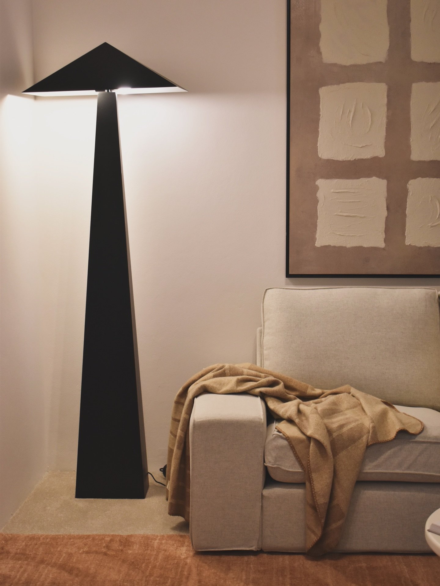 Warm textures, sculptural lighting and soft neutrals help create a space that feels calm and inviting the moment you walk in.