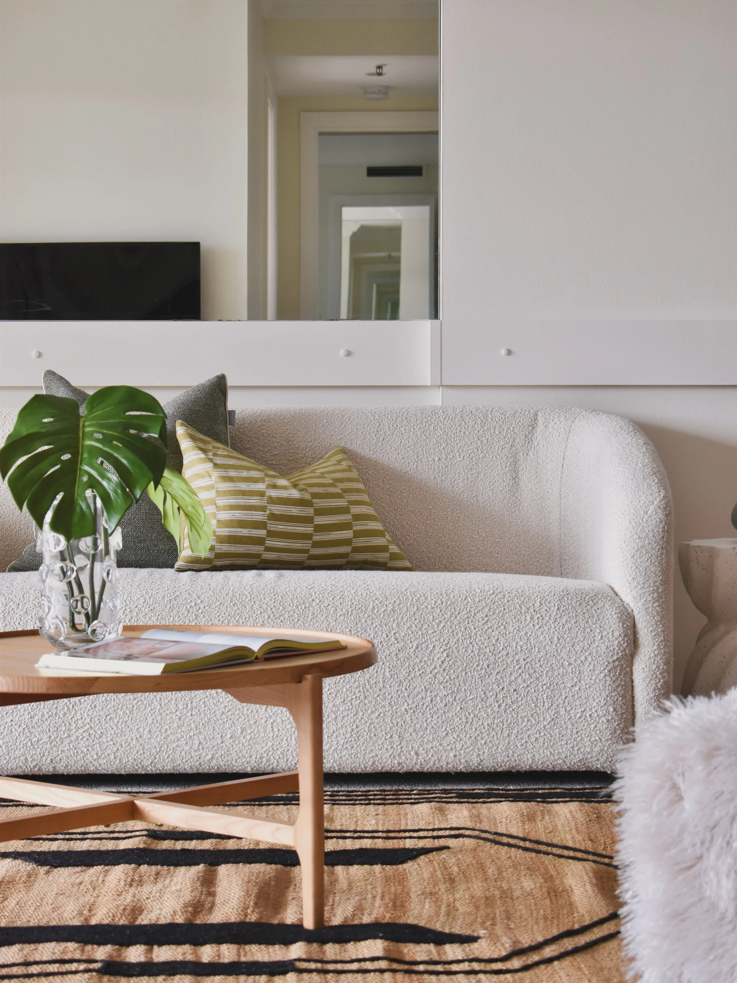 A palette of warm neutrals, earthy greens and playful curves. Layered textures, sculptural forms and thoughtful pops of colour create a space that feels calm, contemporary and effortlessly inviting.