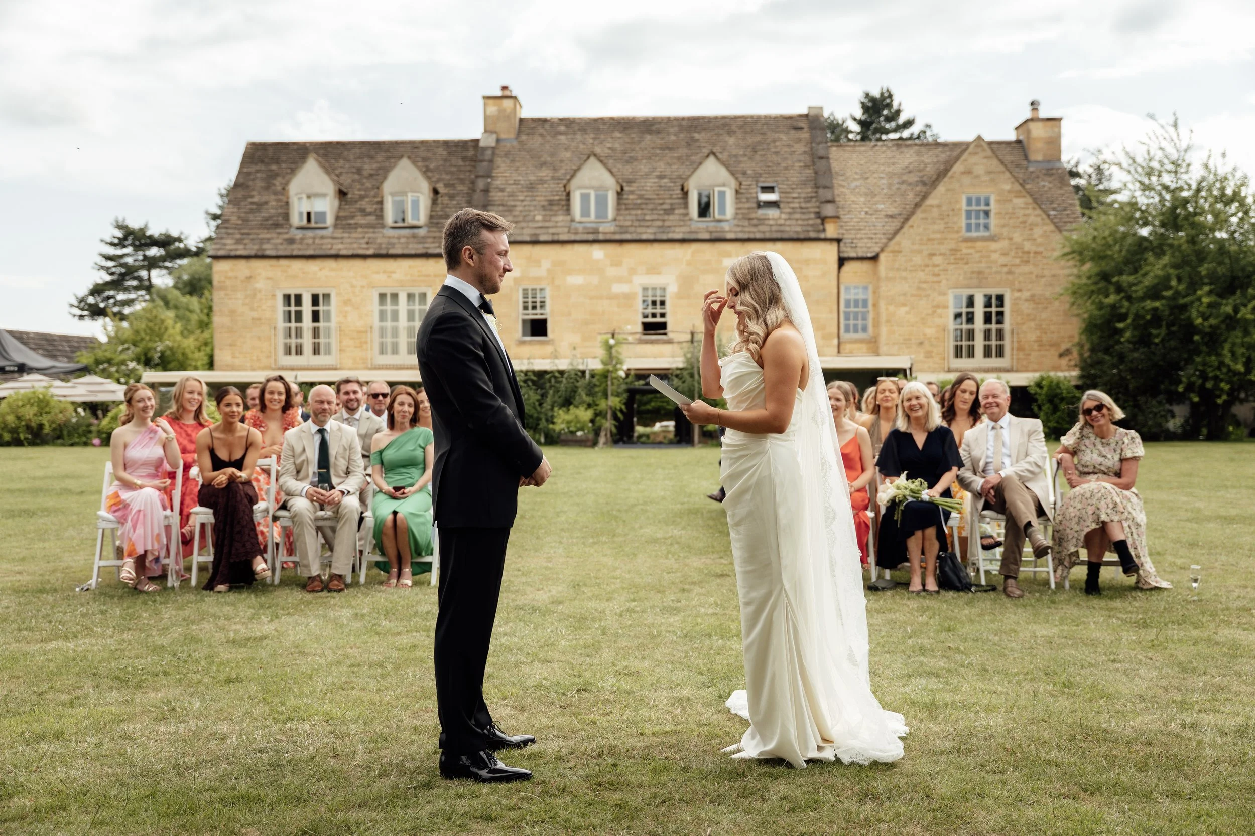 Emotional outdoor wedding ceremony at Charingworth Manor in the Cotswolds, captured by documentary wedding photographer Aleksandra Filipek