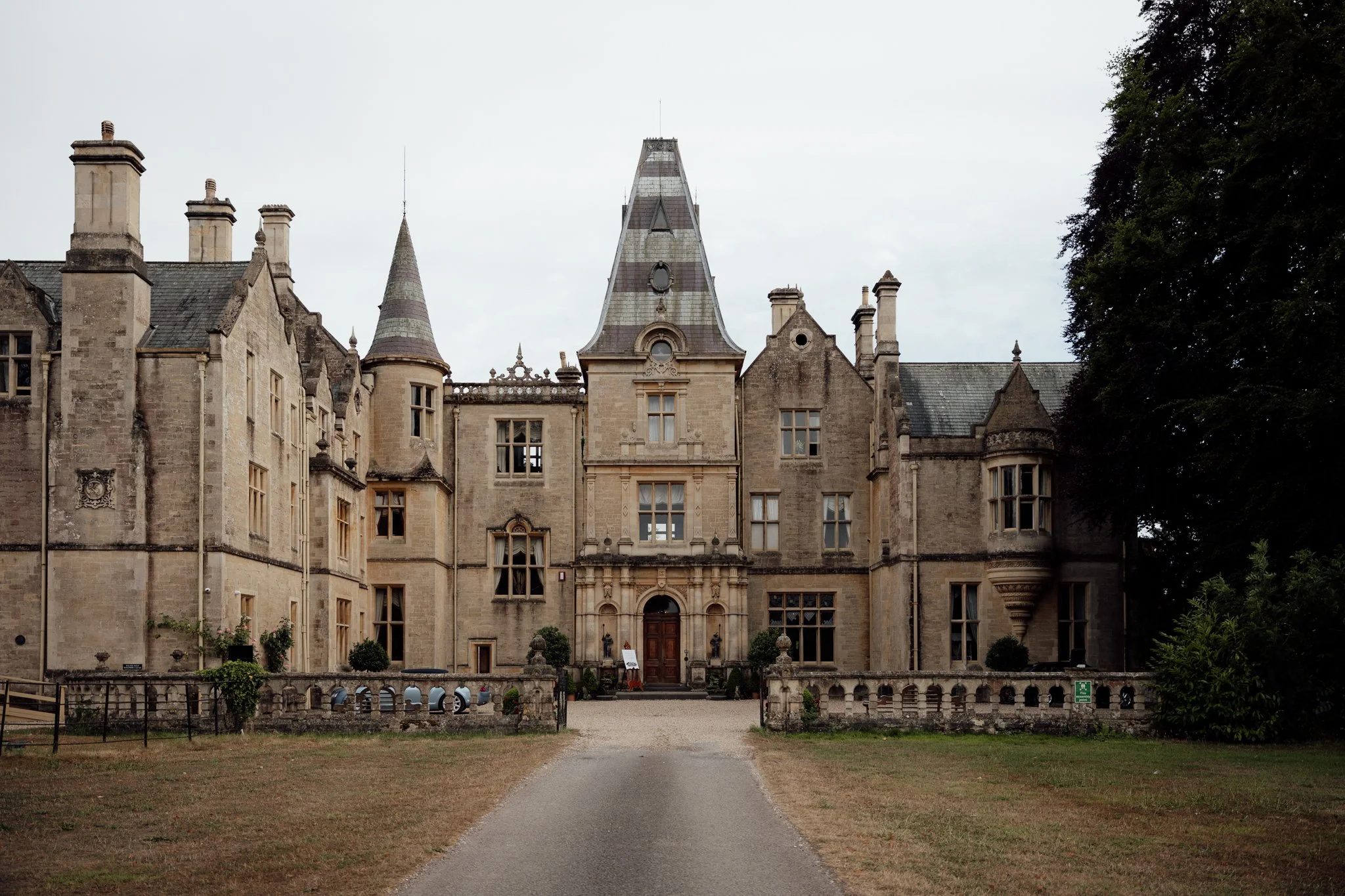 The grand exterior of Orchardleigh Estate in Somerset, a Victorian Gothic wedding venue captured by Aleksandra Filipek Photography