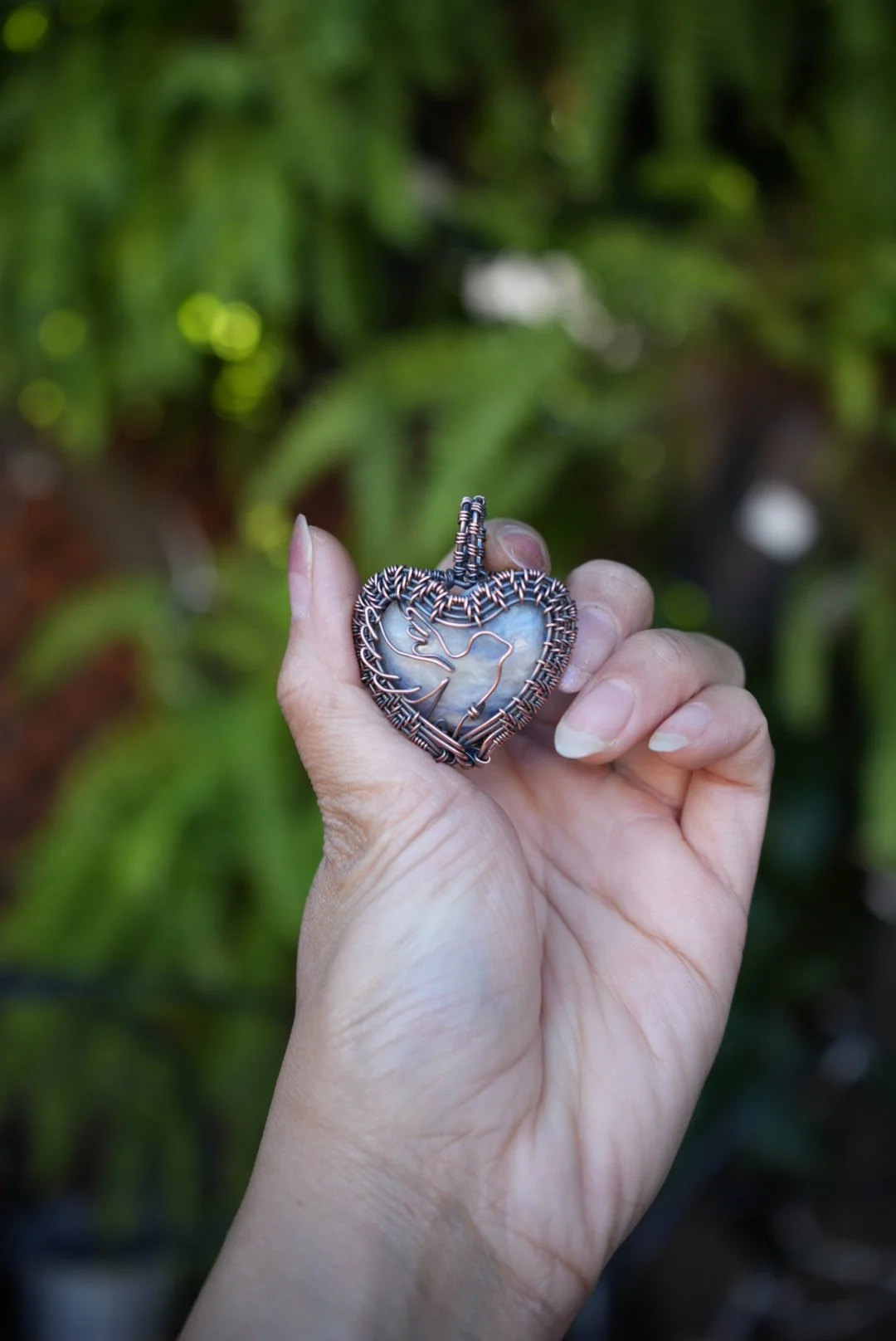 Bird soaring through the sky heart pendant