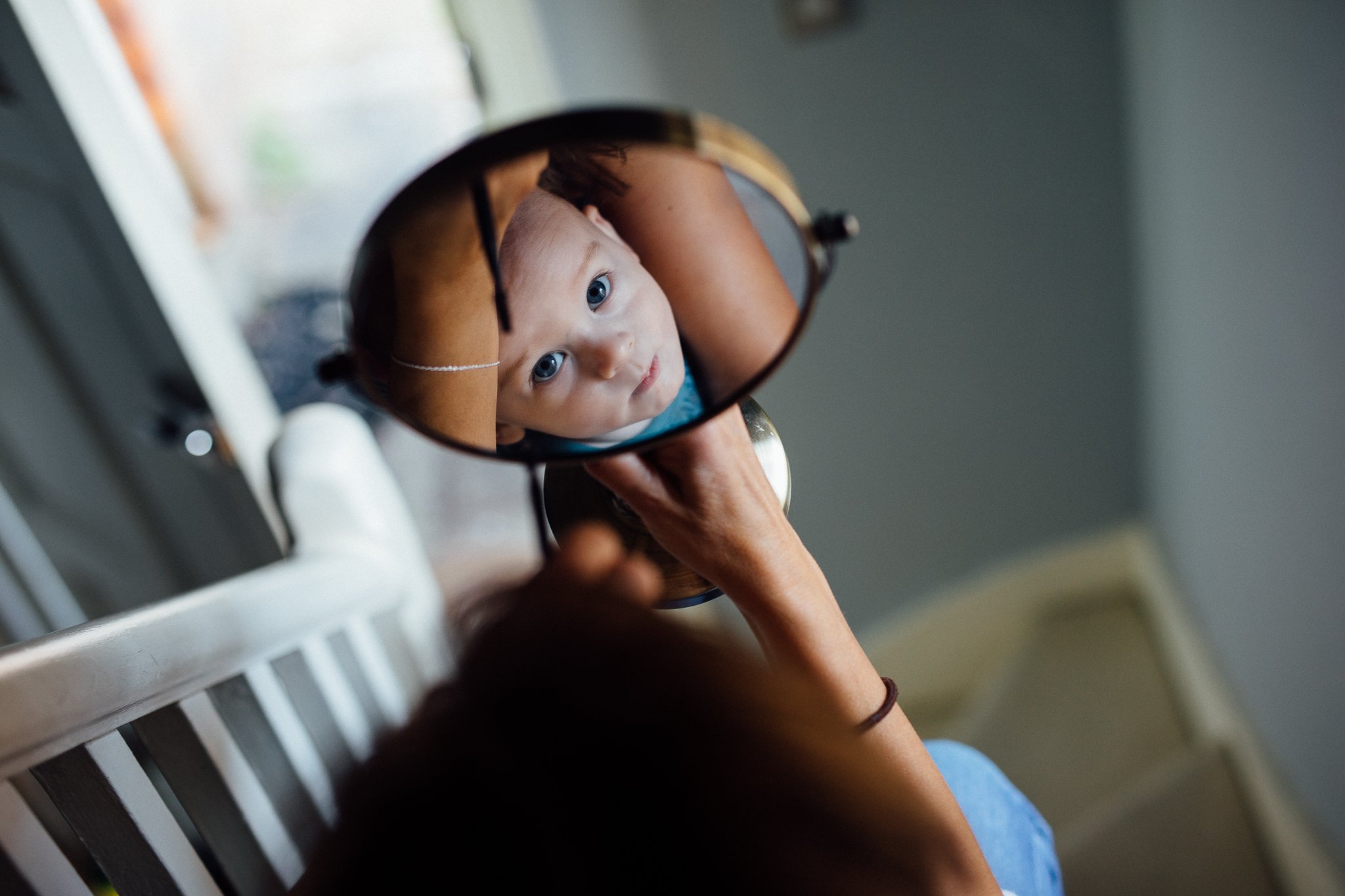  Baby looking at the camera via the reflection in a mirror 