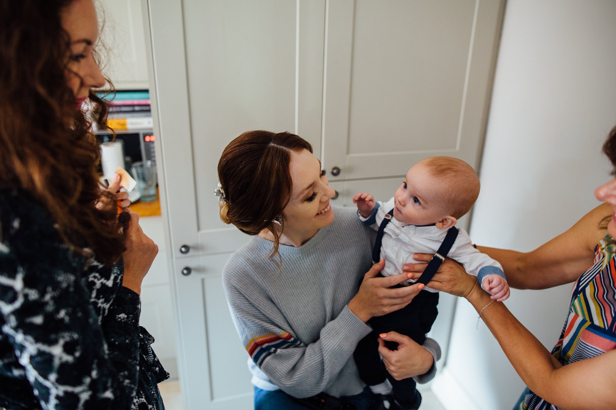  Bride looking at one of her twin sons 