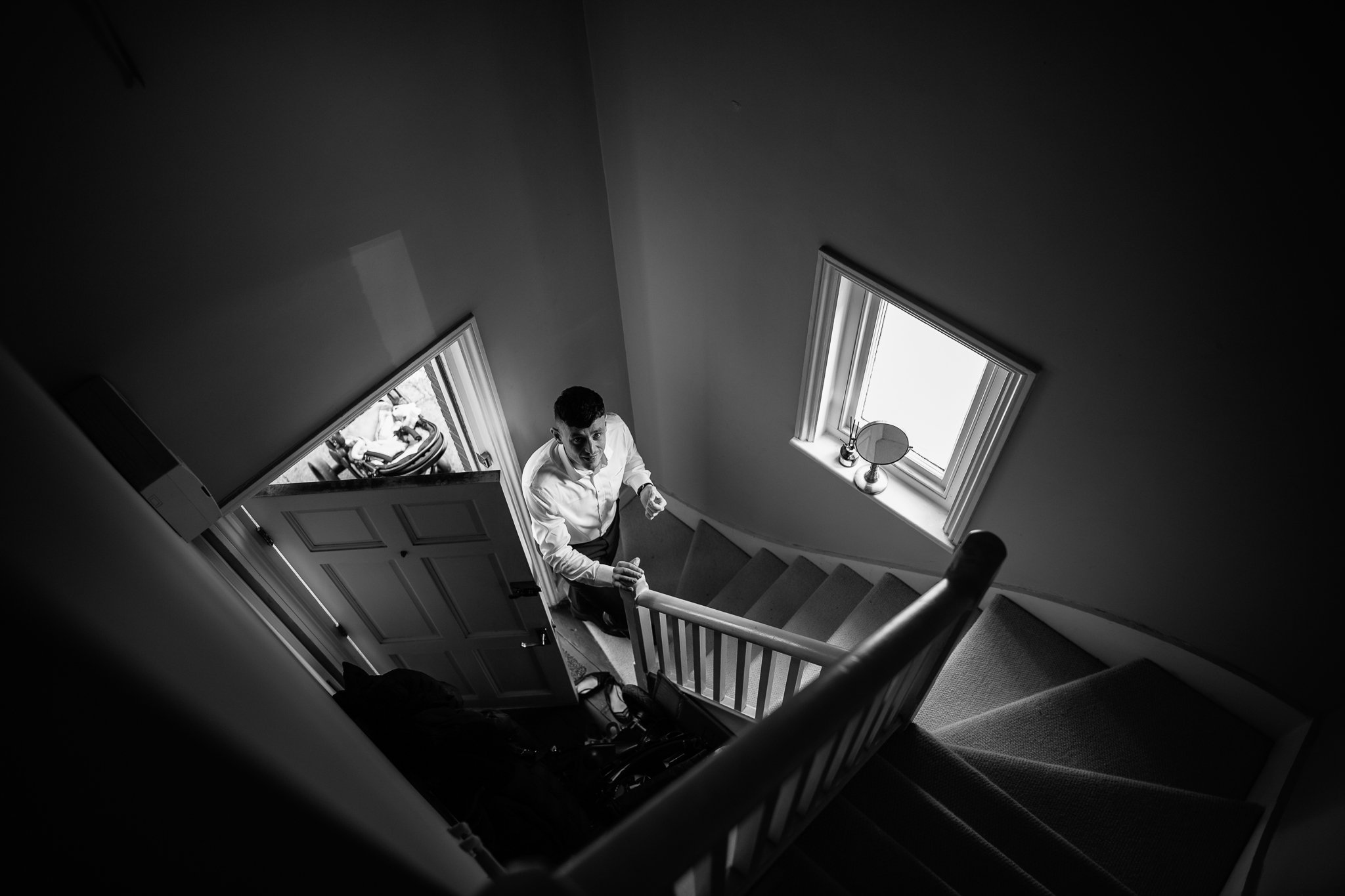  Groom walking up the stairs of his house 