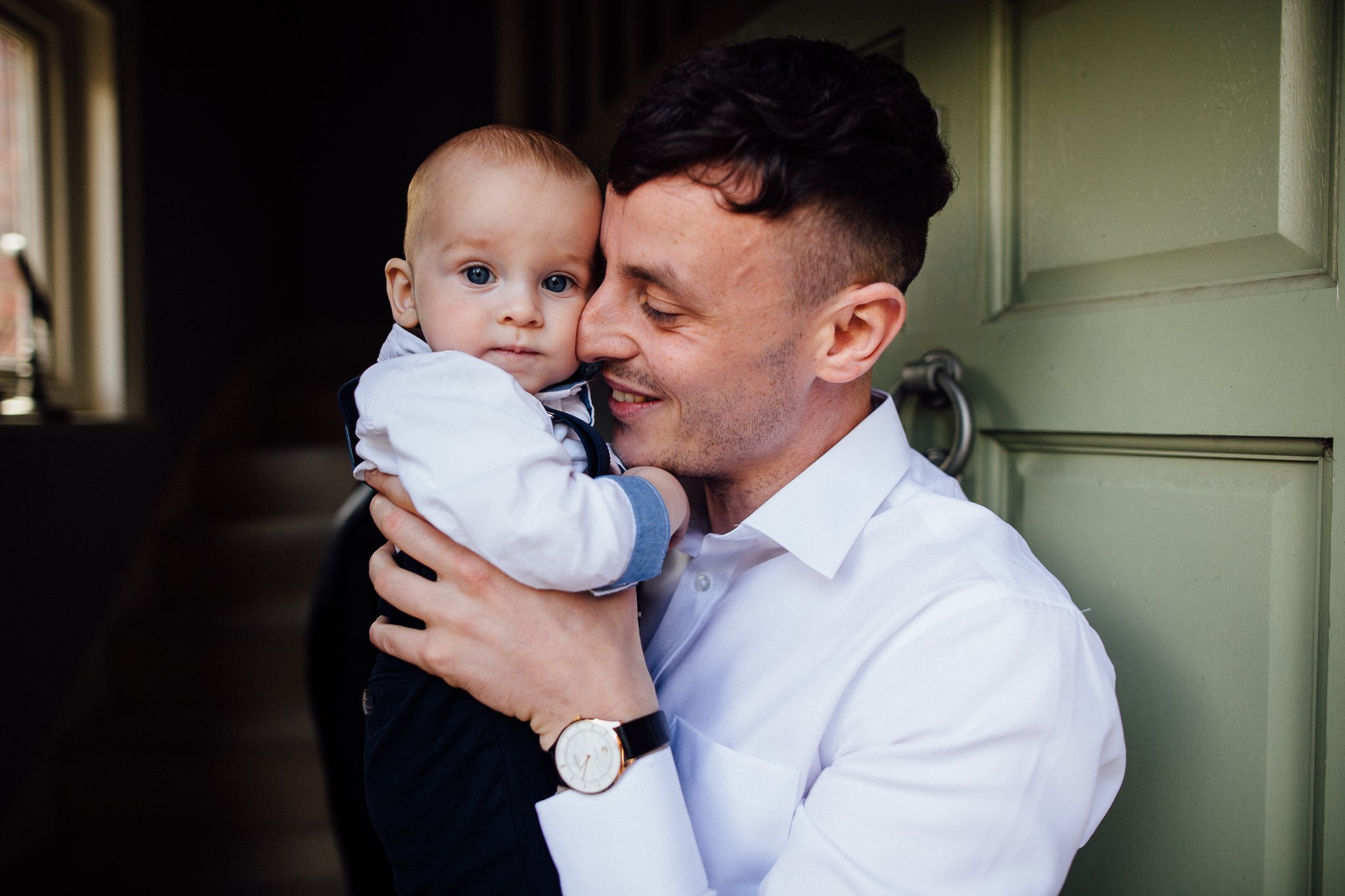  Groom cuddling his son. 