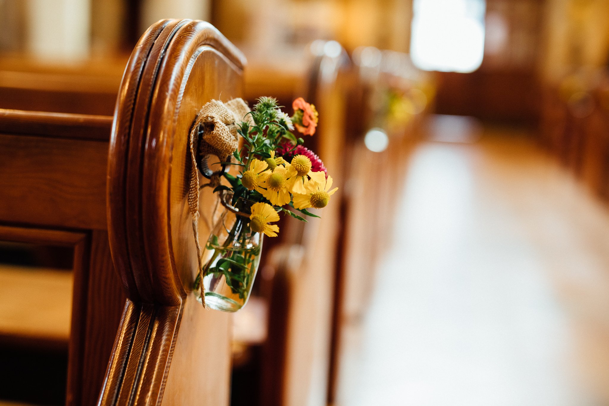  Flowers hanging from a pew in The Holy Family Church in Reigate 