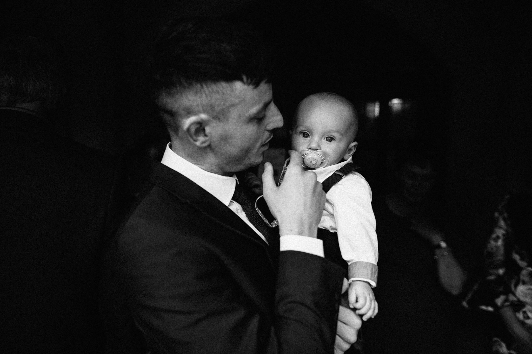  Groom holding his son in The Holy Family Church in Reigate 