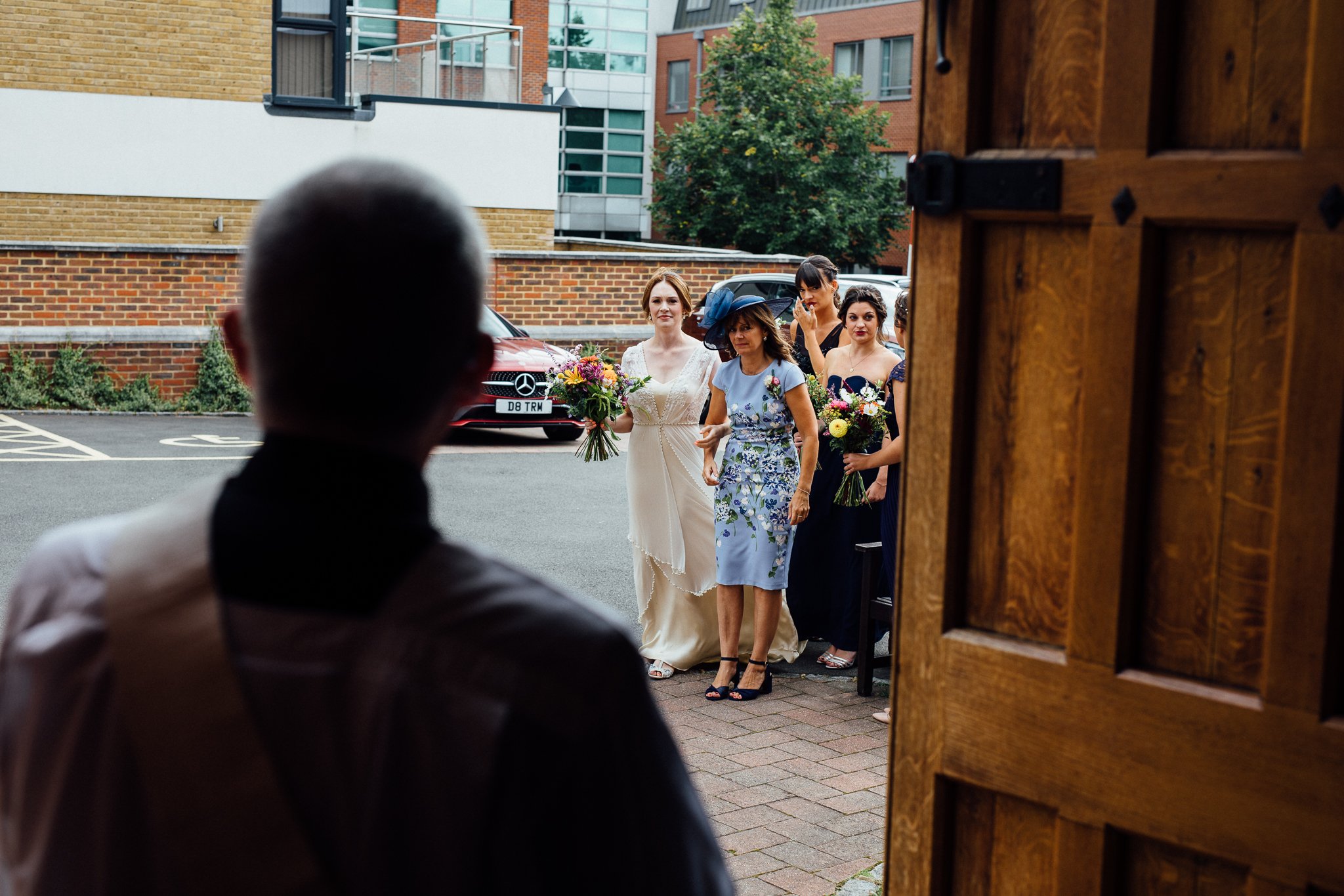  Bridal party approach The Holy Family Church in Reigate 