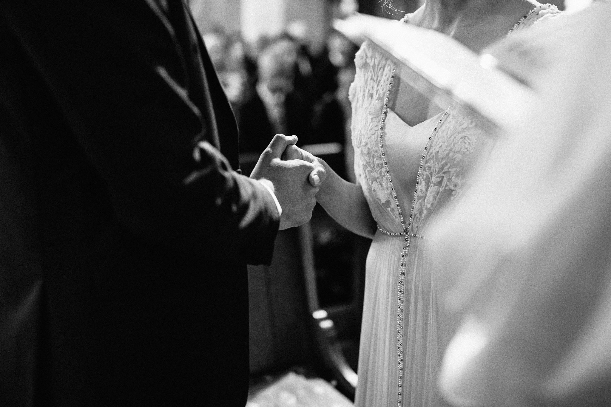  The bride and groom hold hands 