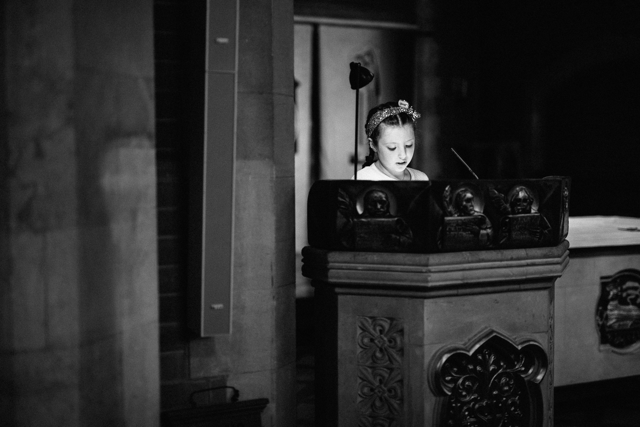  A small girl makes a reading at The Holy Family Church in Reigate 