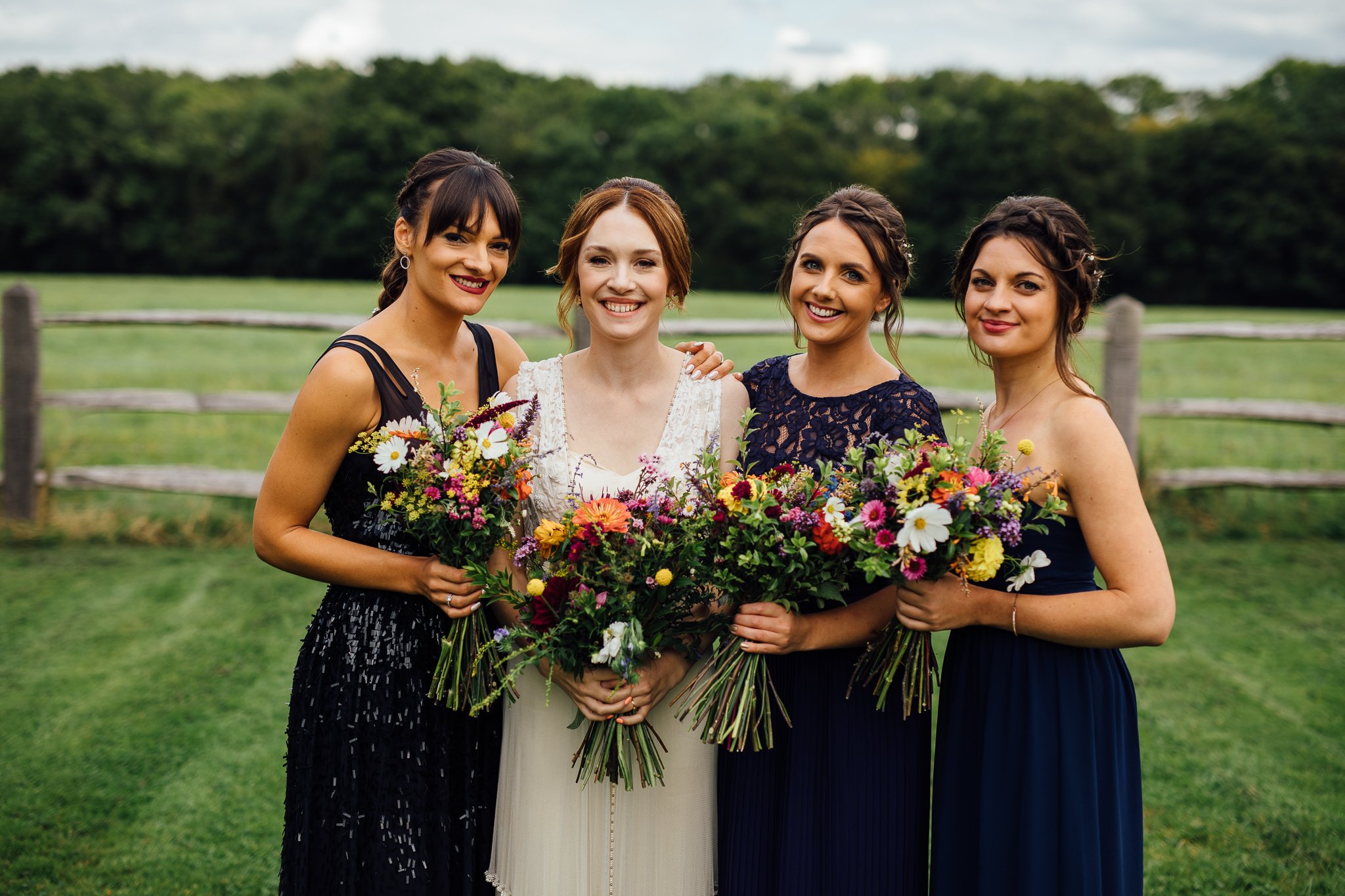  Bride posing with her bridal party at Gildings Barns in Newdigate Surrey 