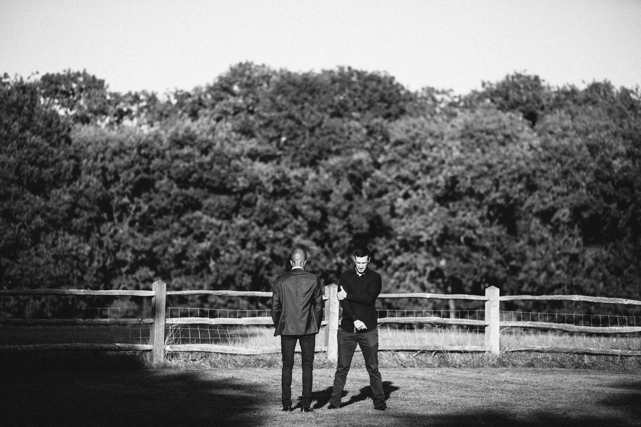  Two men stand in opposite directions at Gildings Barns in Newdigate Surrey 