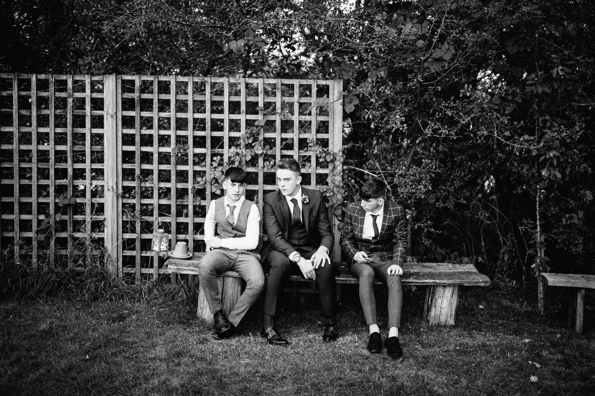 Young men sitting on a bench at Gildings Barns in Newdigate Surrey 