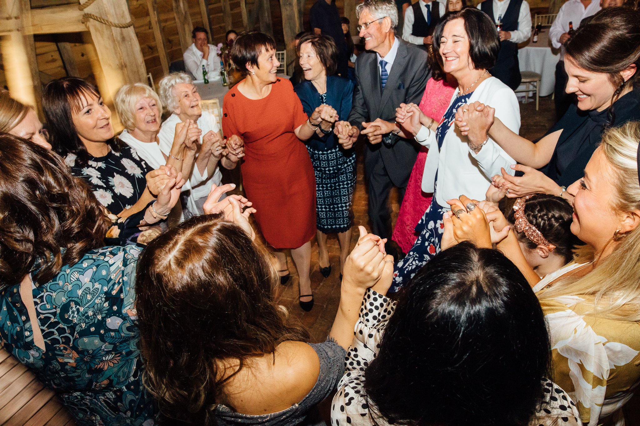  Wedding guests dancing at Gildings Barns in Newdigate Surrey 