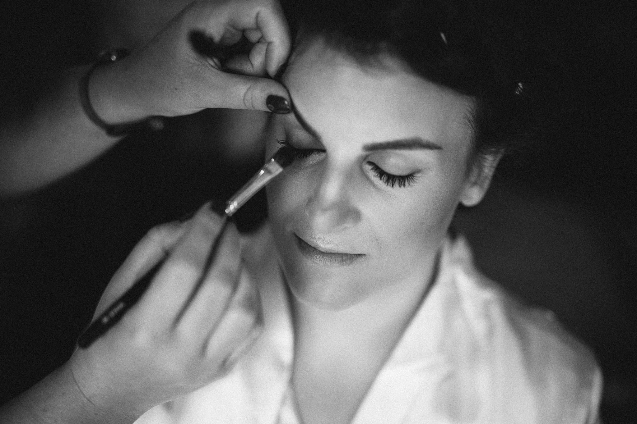  Bride has eye makeup applied 