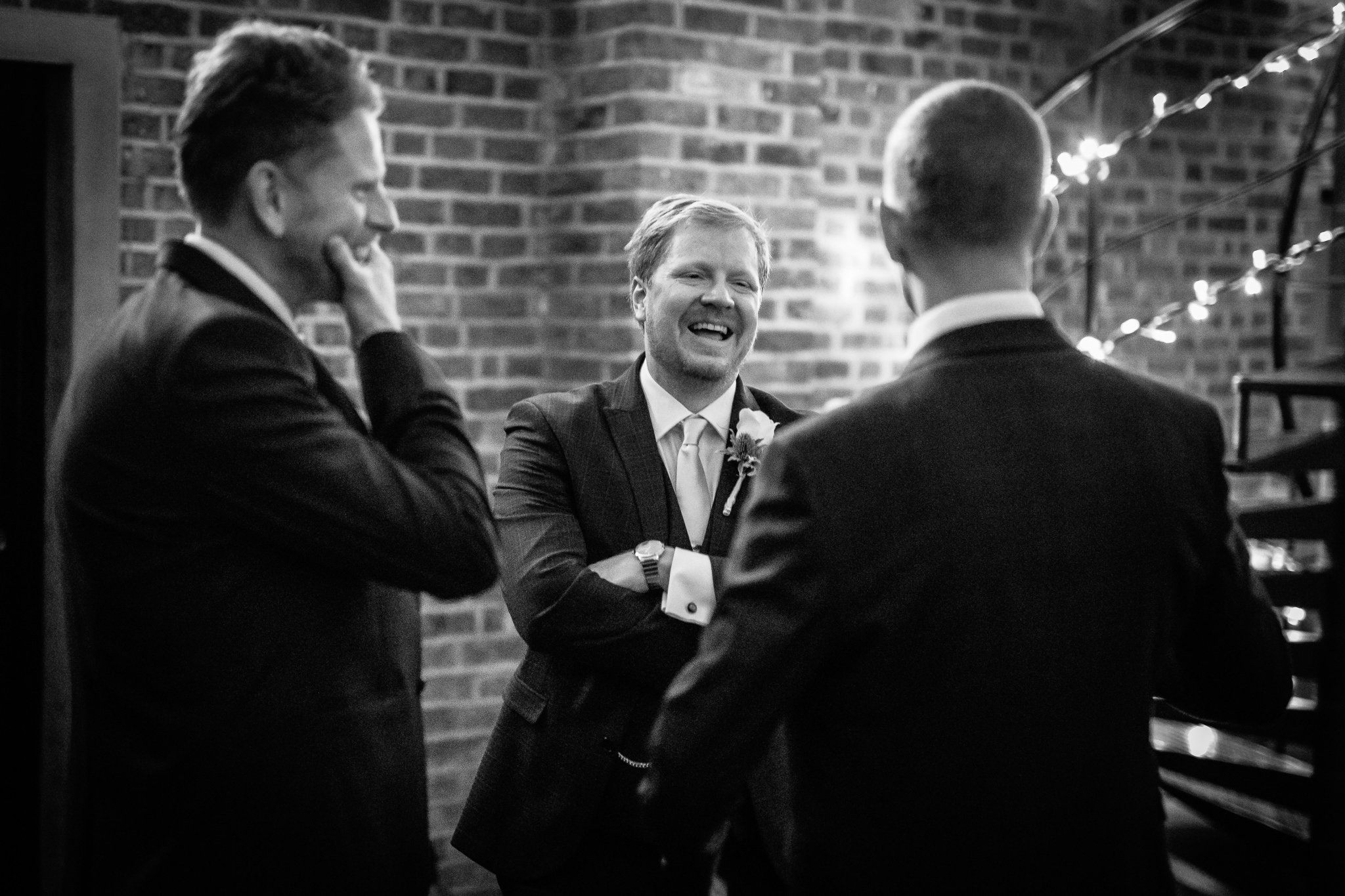  Groom laughs inside Shoreditch Studios on his wedding day. 