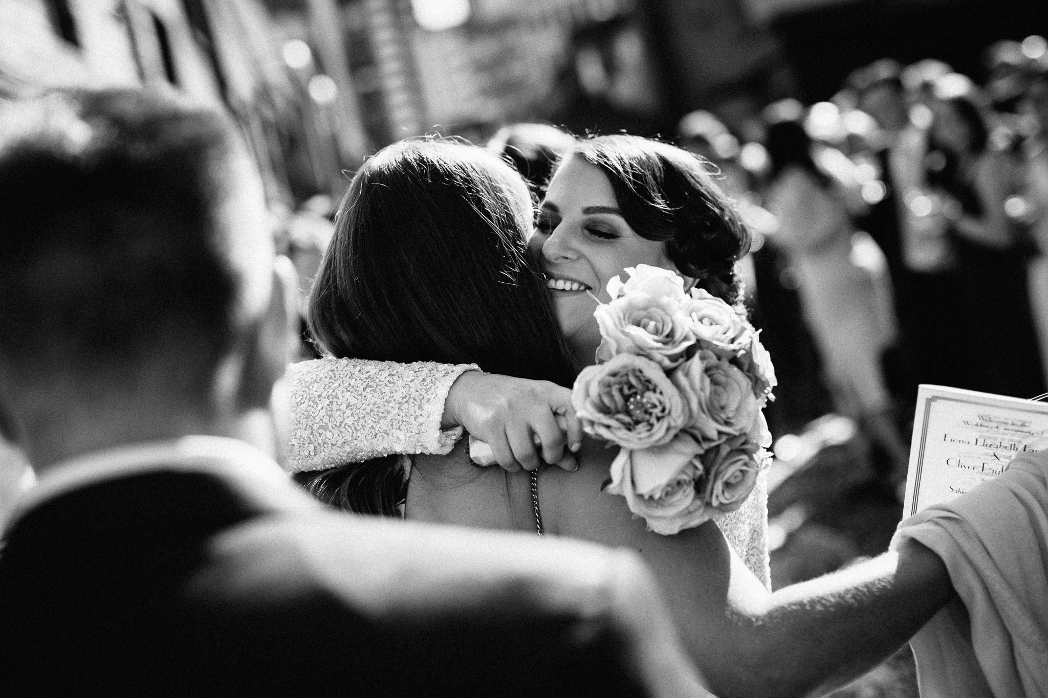  Bride hugs a friend. 