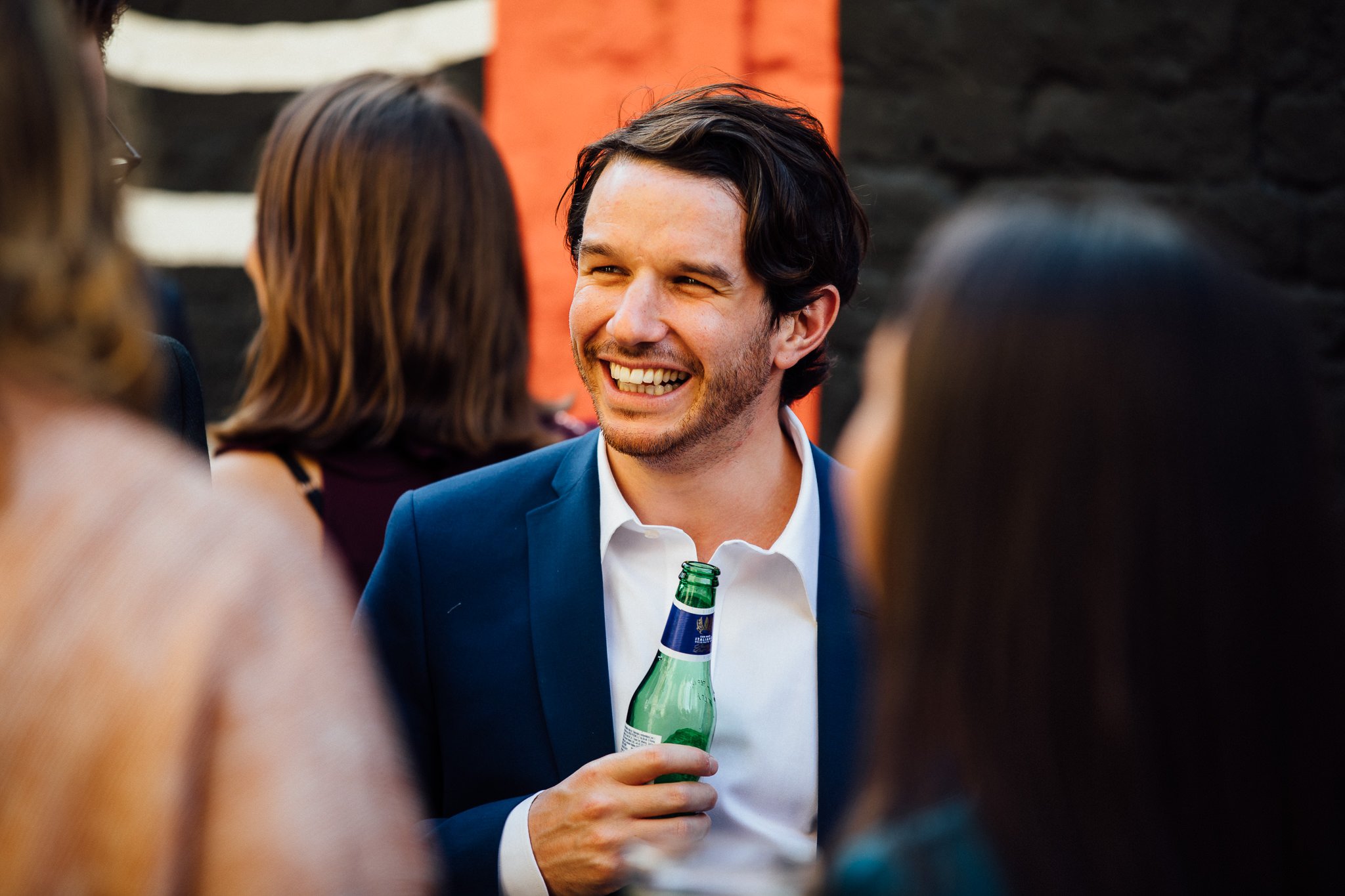  Guest smiling whilst holding a beer. 