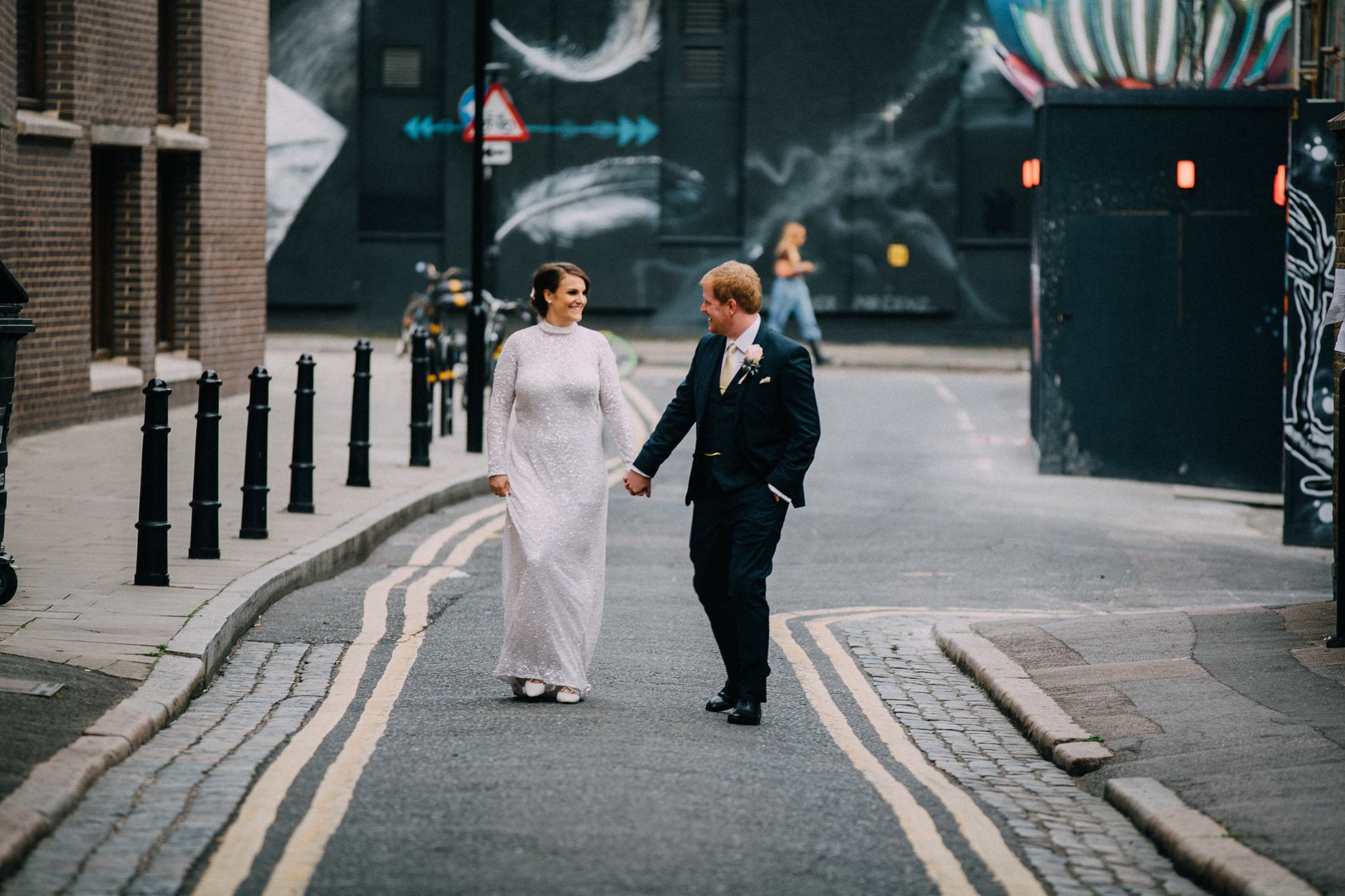  Bride and Groom holding hands outside Shoreditch Studios. 