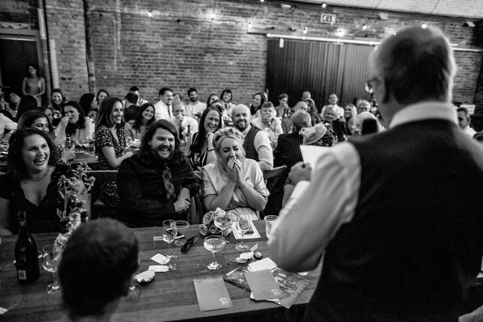  Guests laughing at the speech. 