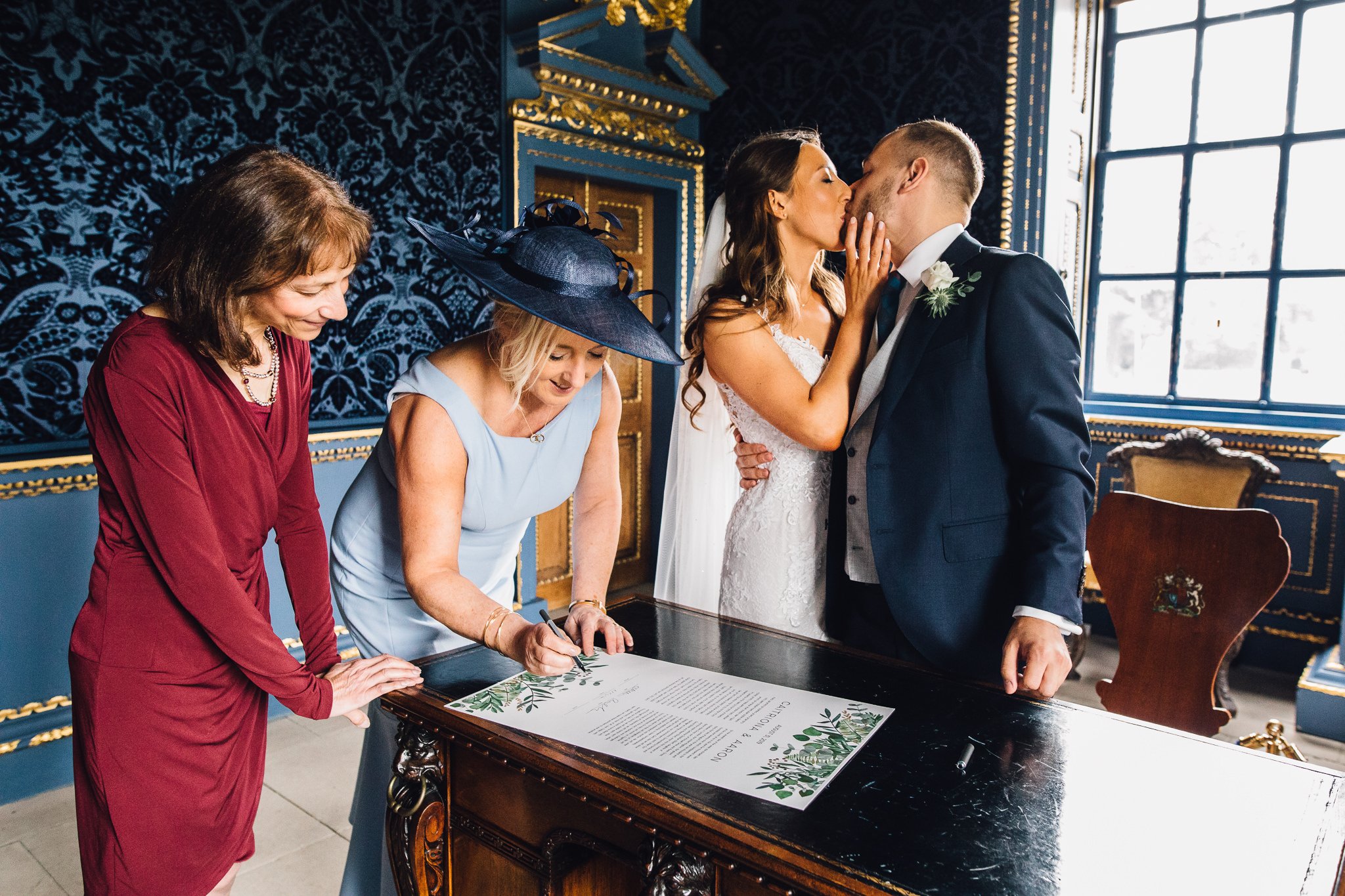  Bride and Groom kiss at Chiswick House as the marriage certificate is signed 