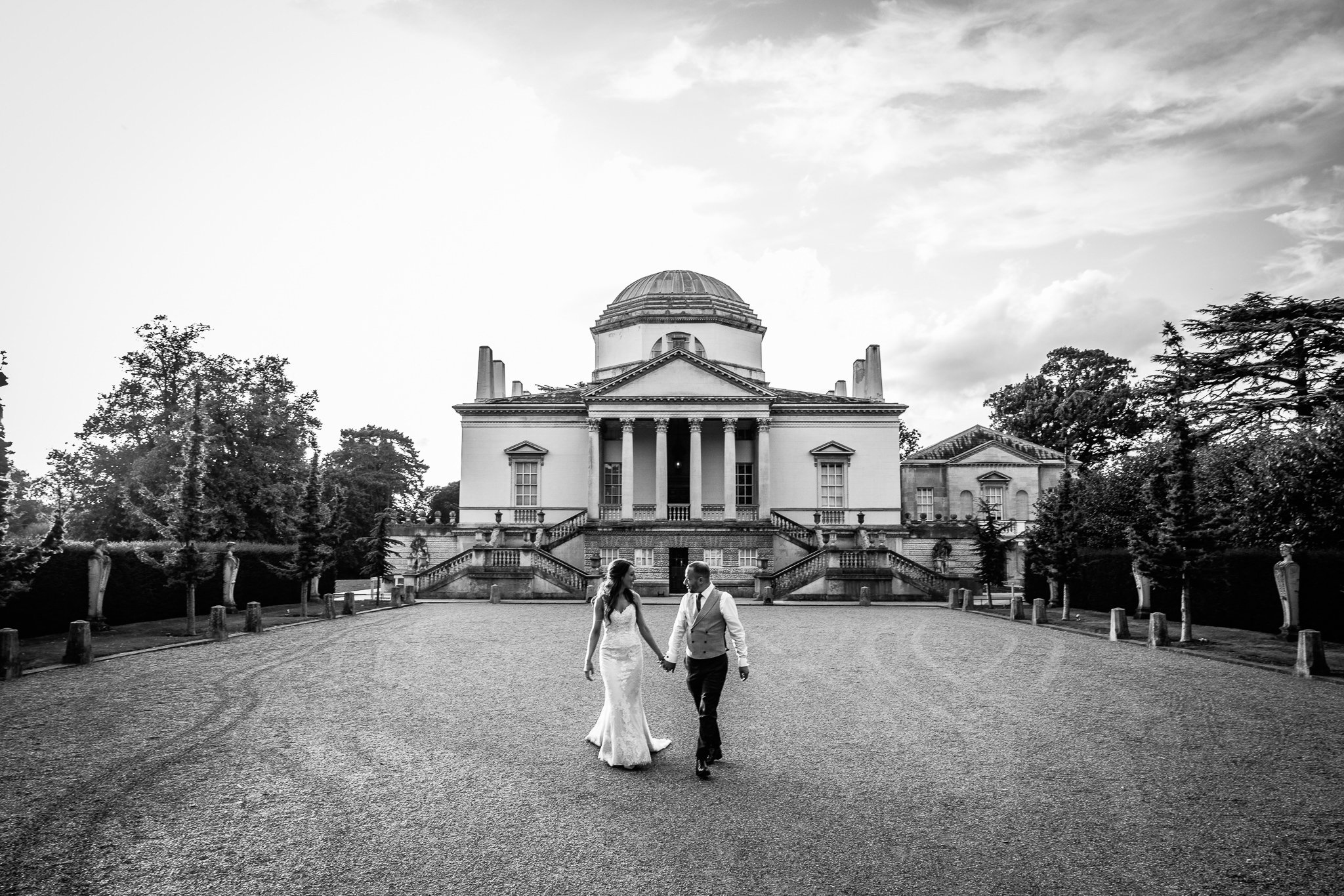  Bride and Groom walk together outside Chiswick House 