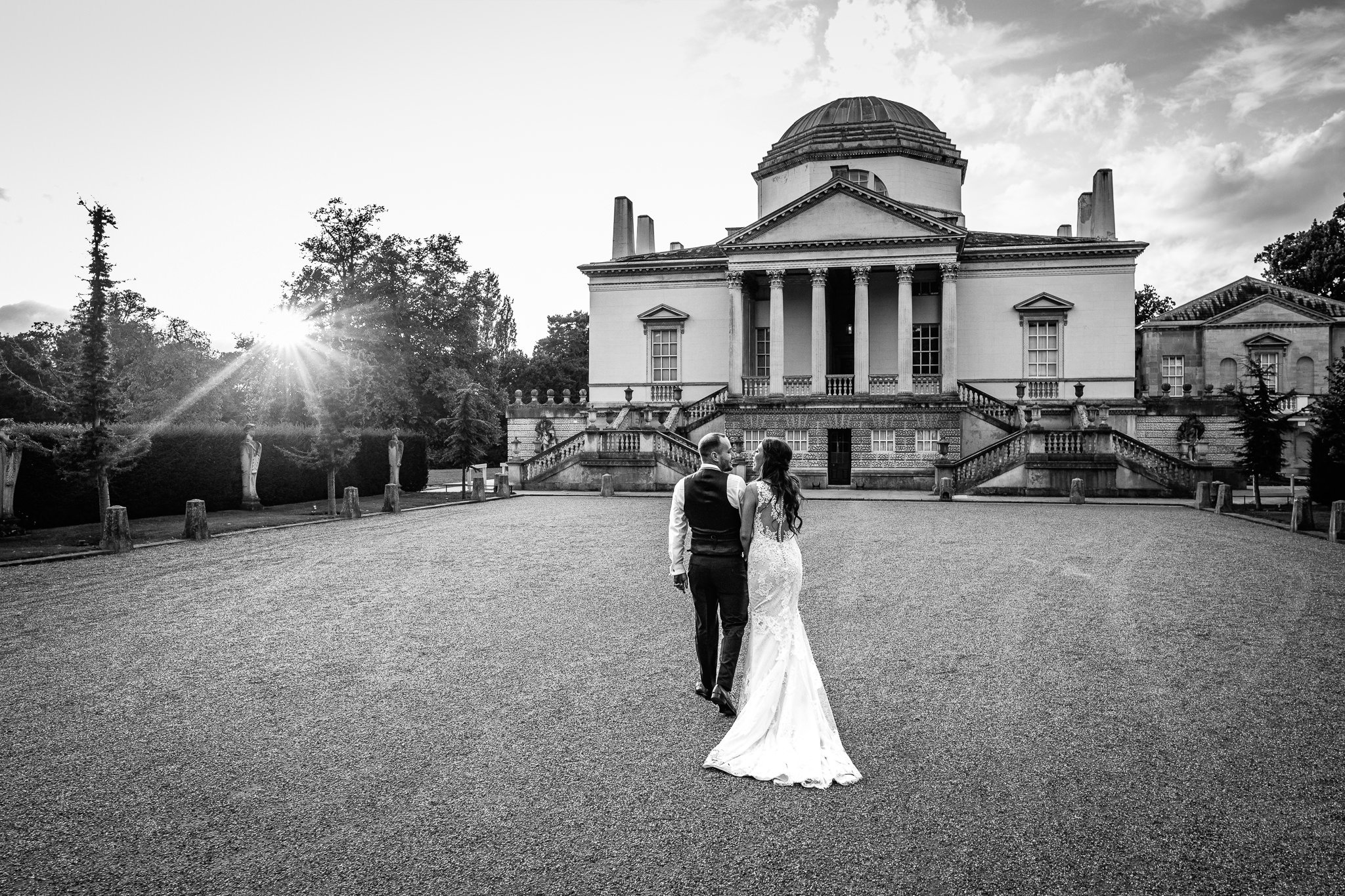  Bride and Groom look at each other as the sun sets behind Chiswick House 