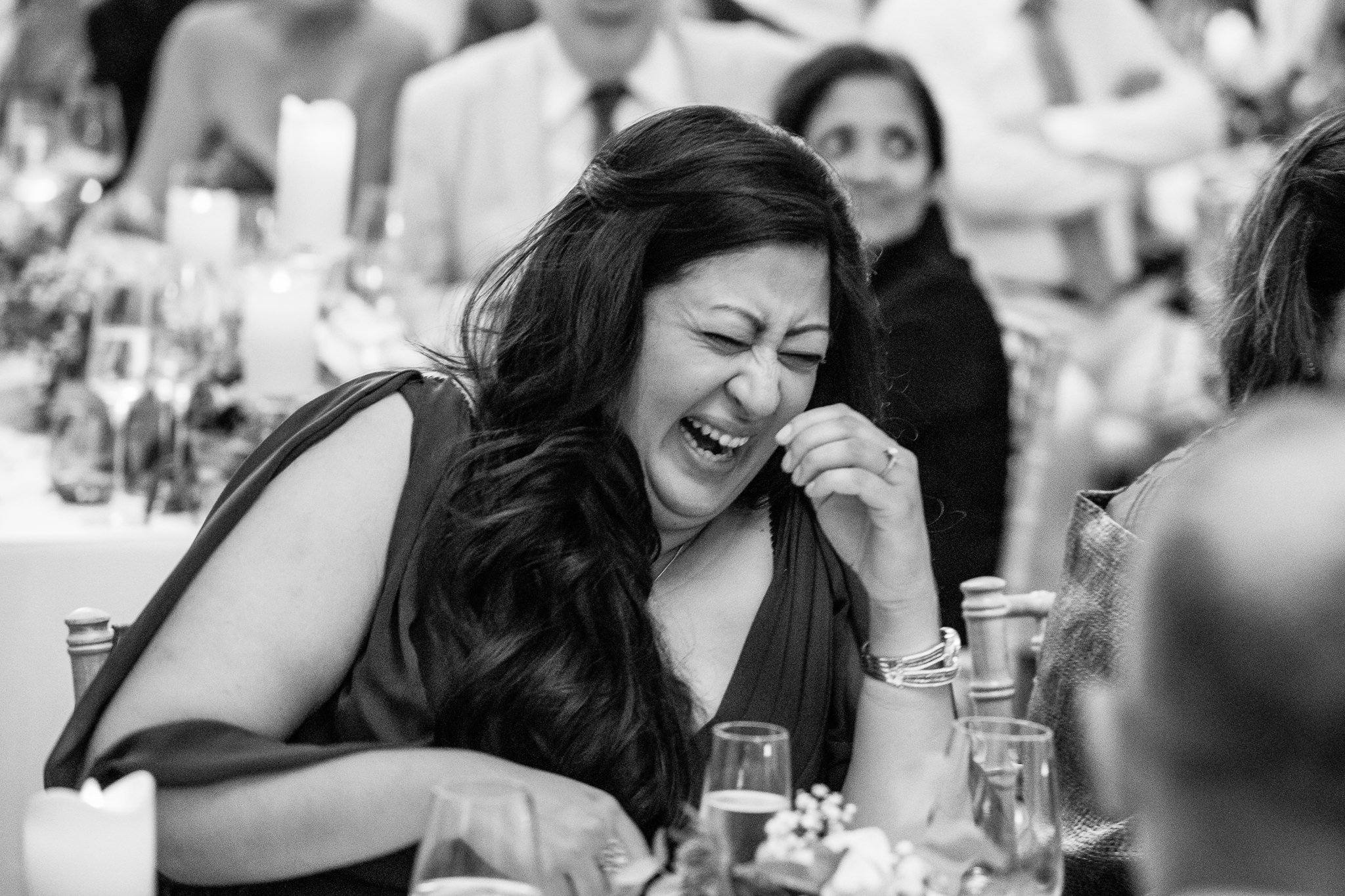  Wedding guest in fits of laughter at the wedding speeches 