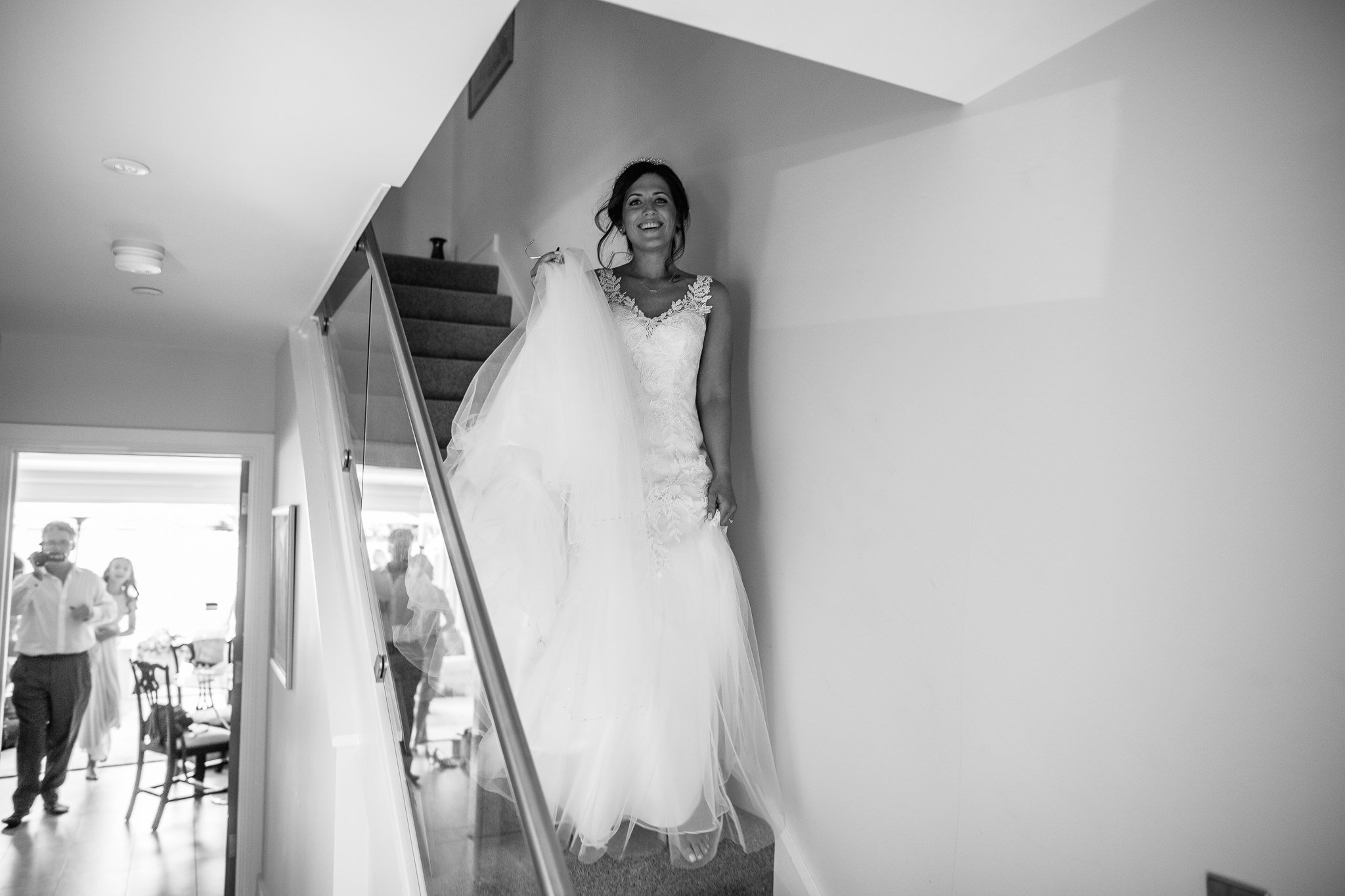  Bride coming downstairs with a big smile on her face. 