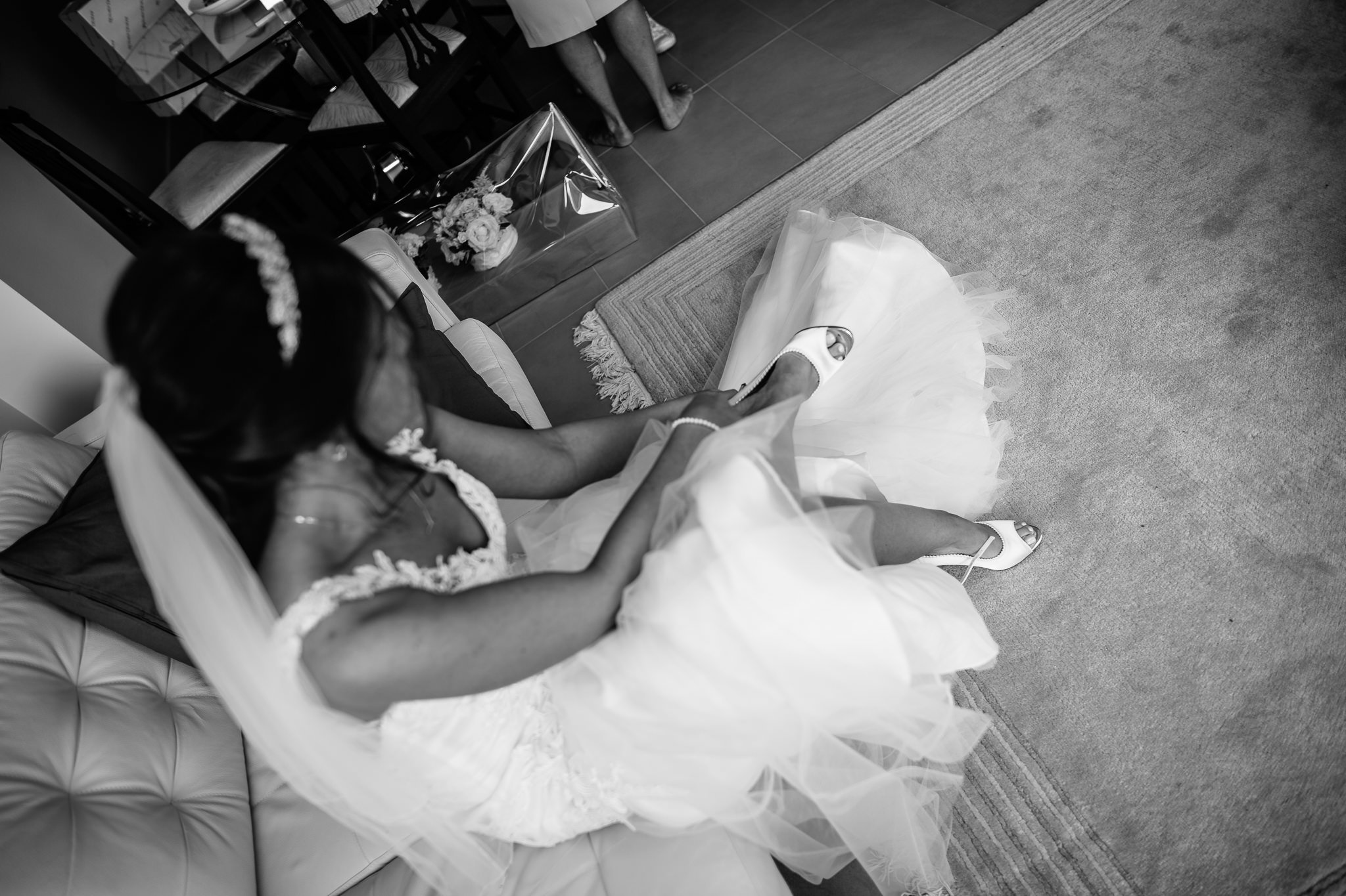  Bride puts on her shoes on her wedding day 