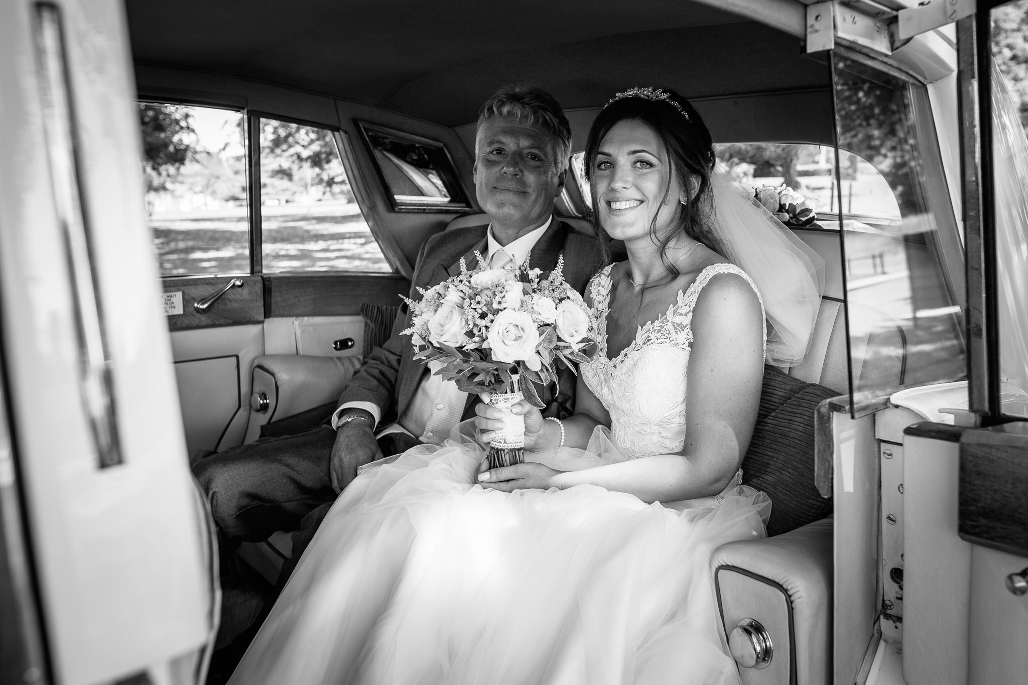  Bride and Father of the Bride in a Rolls Royce outside  the Chapel of St Luke at Epsom College 