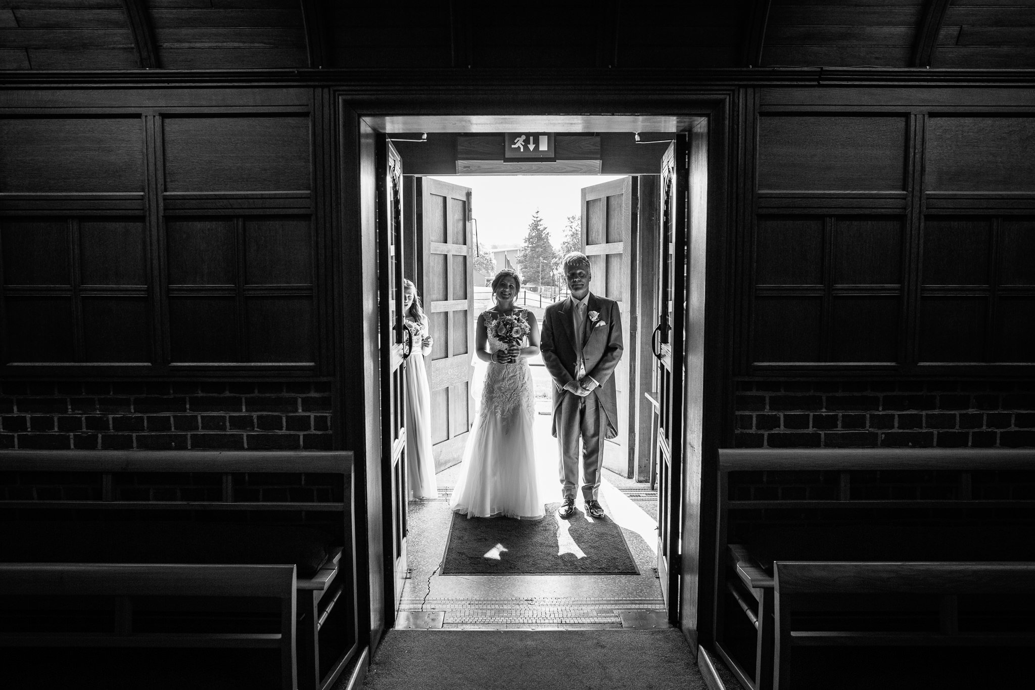  Bride and the Father of the Bride ready to enter  the Chapel of St Luke at Epsom College 