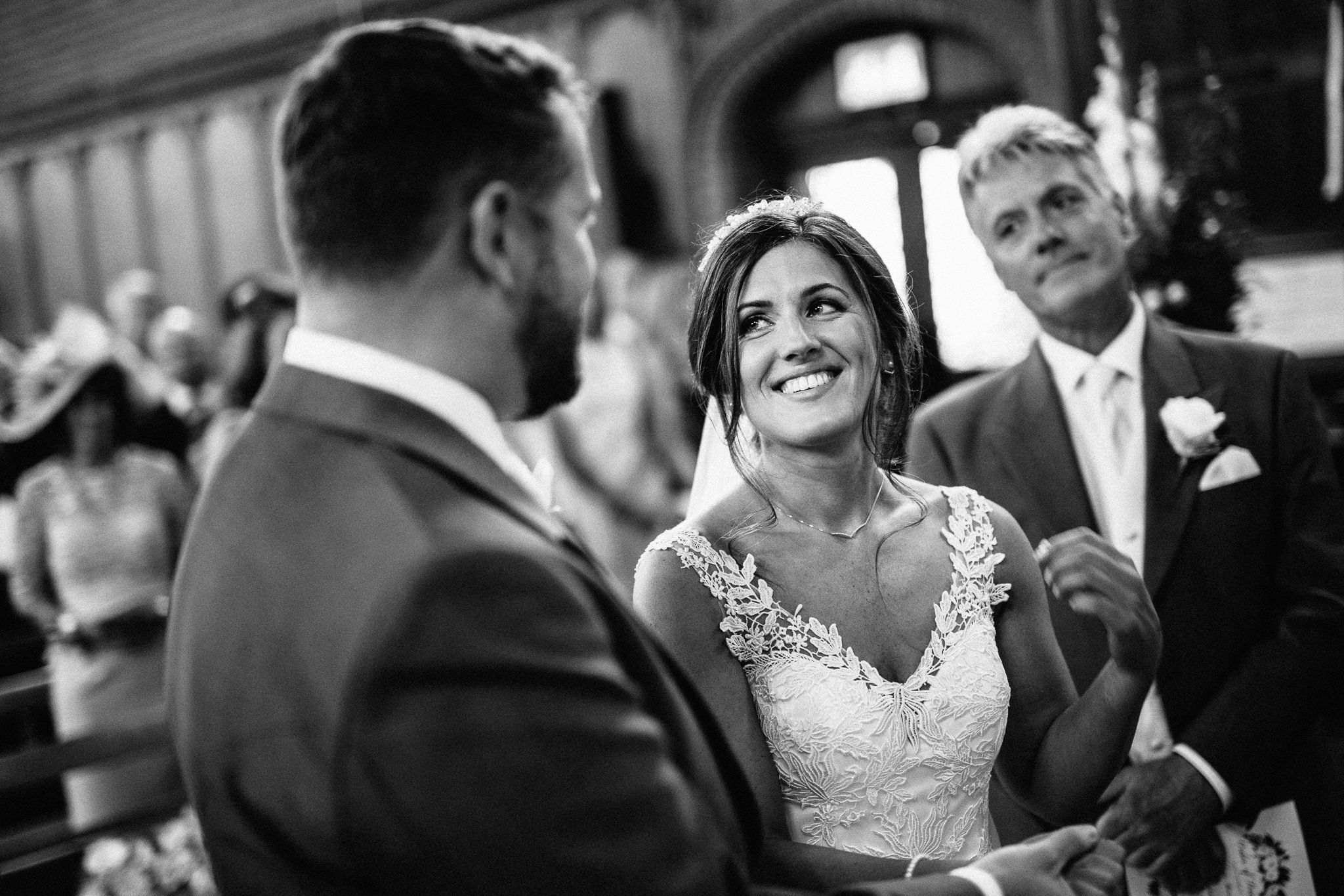  Beautiful bride smiling  at the Chapel of St Luke at Epsom College 