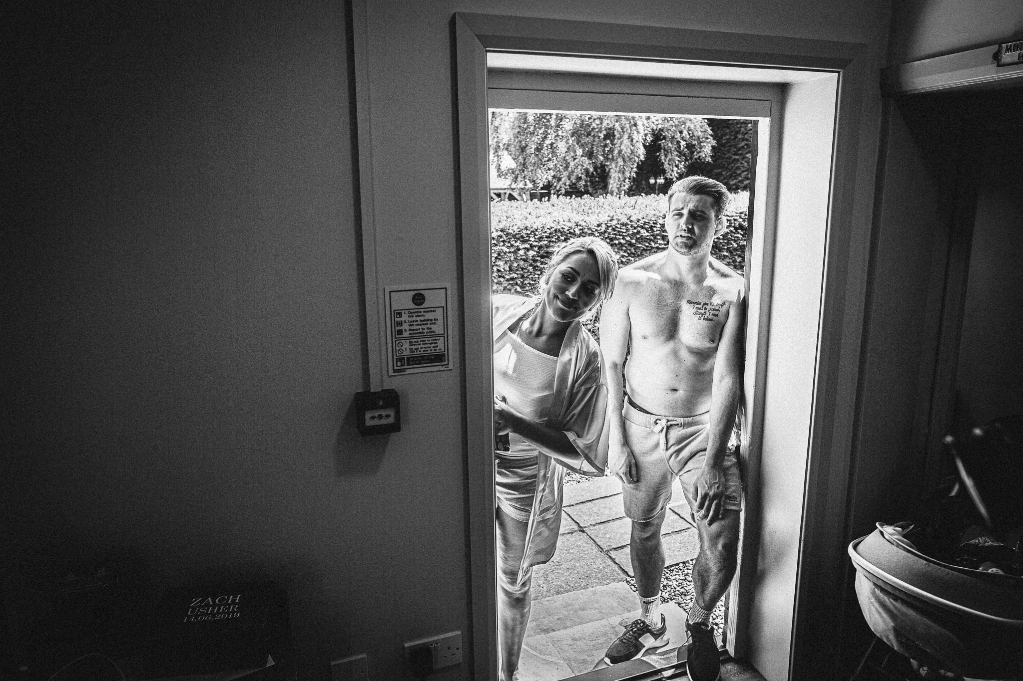  Groomsman and bridesmaid looks into the room 