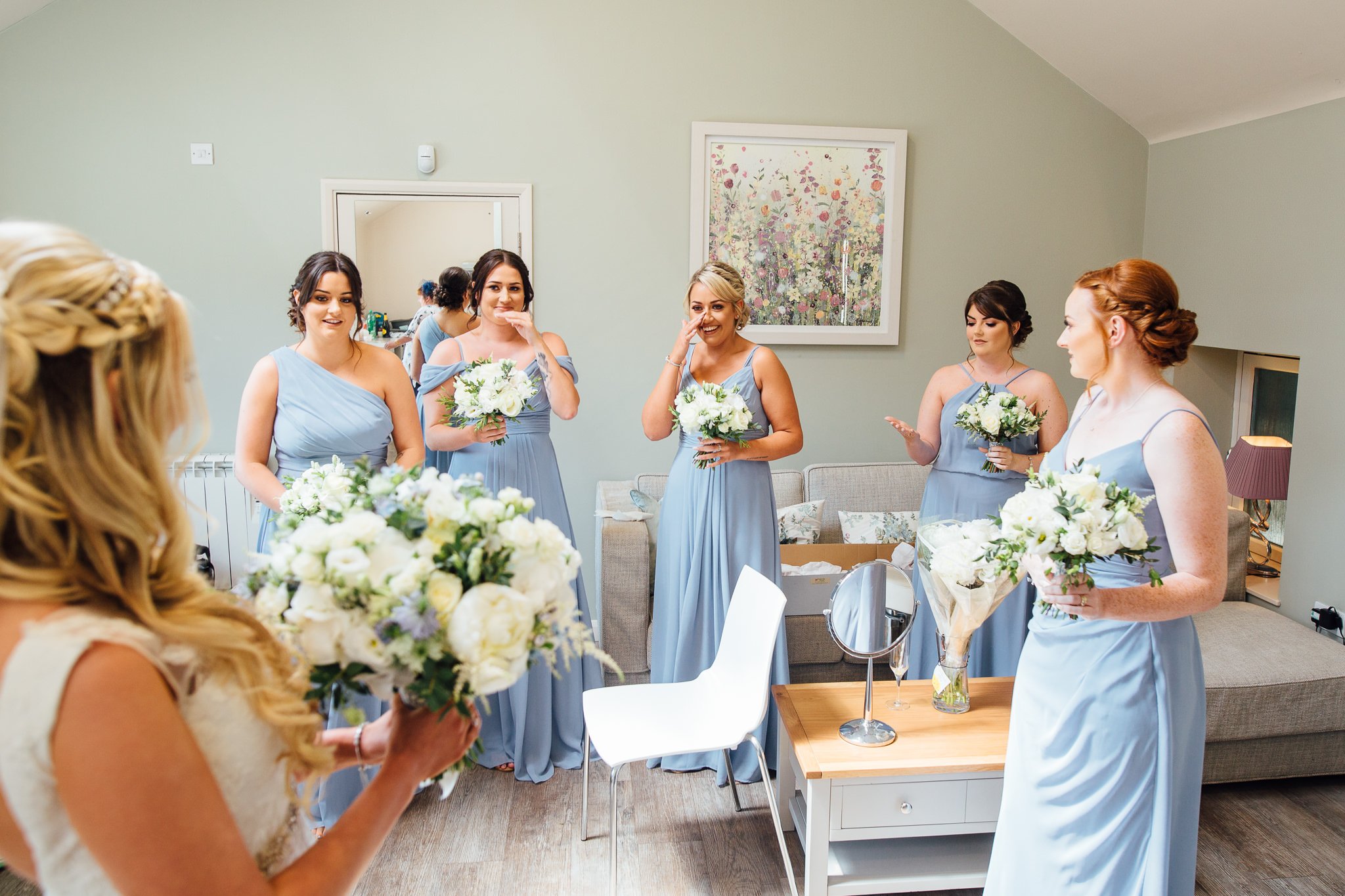  A bridesmaid wipes away a tear at seeing the Bride ready for her wedding day 