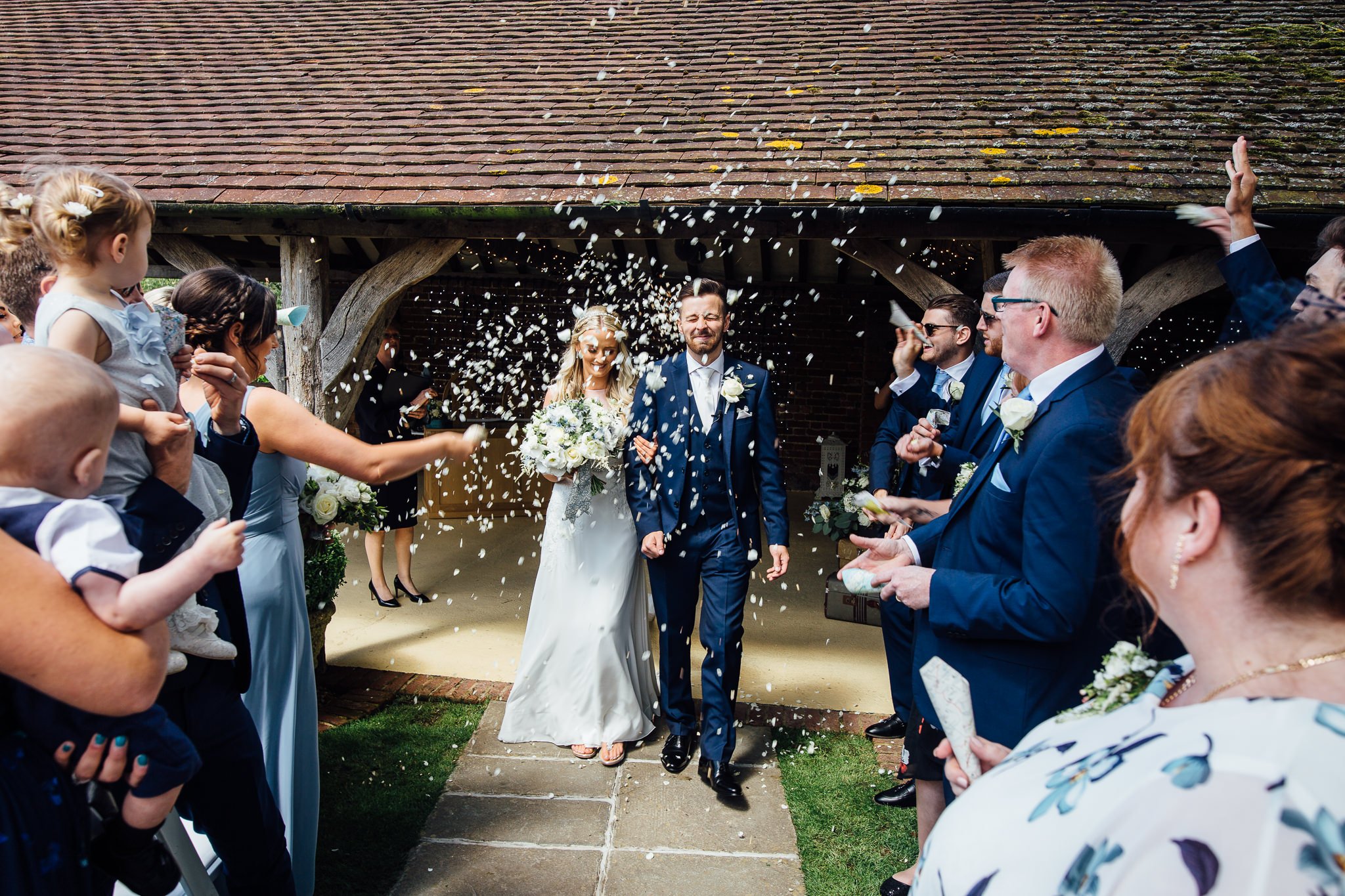  Bride and groom have confetti thrown at them at Winters Barns Wedding Venue Kent 