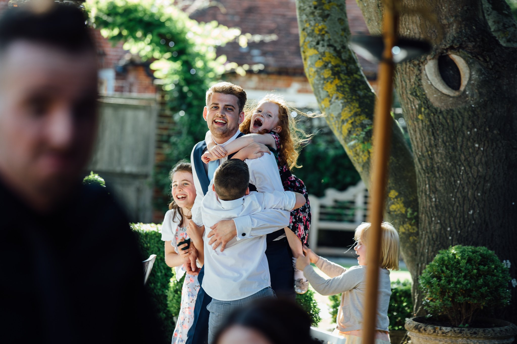  Wedding guest is climbed on by children 