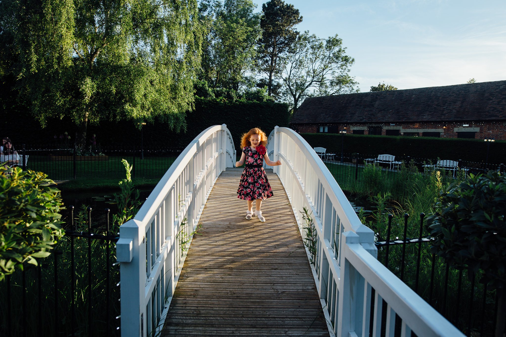  Child plays on a bridge at Winters Barns Wedding Venue Kent 