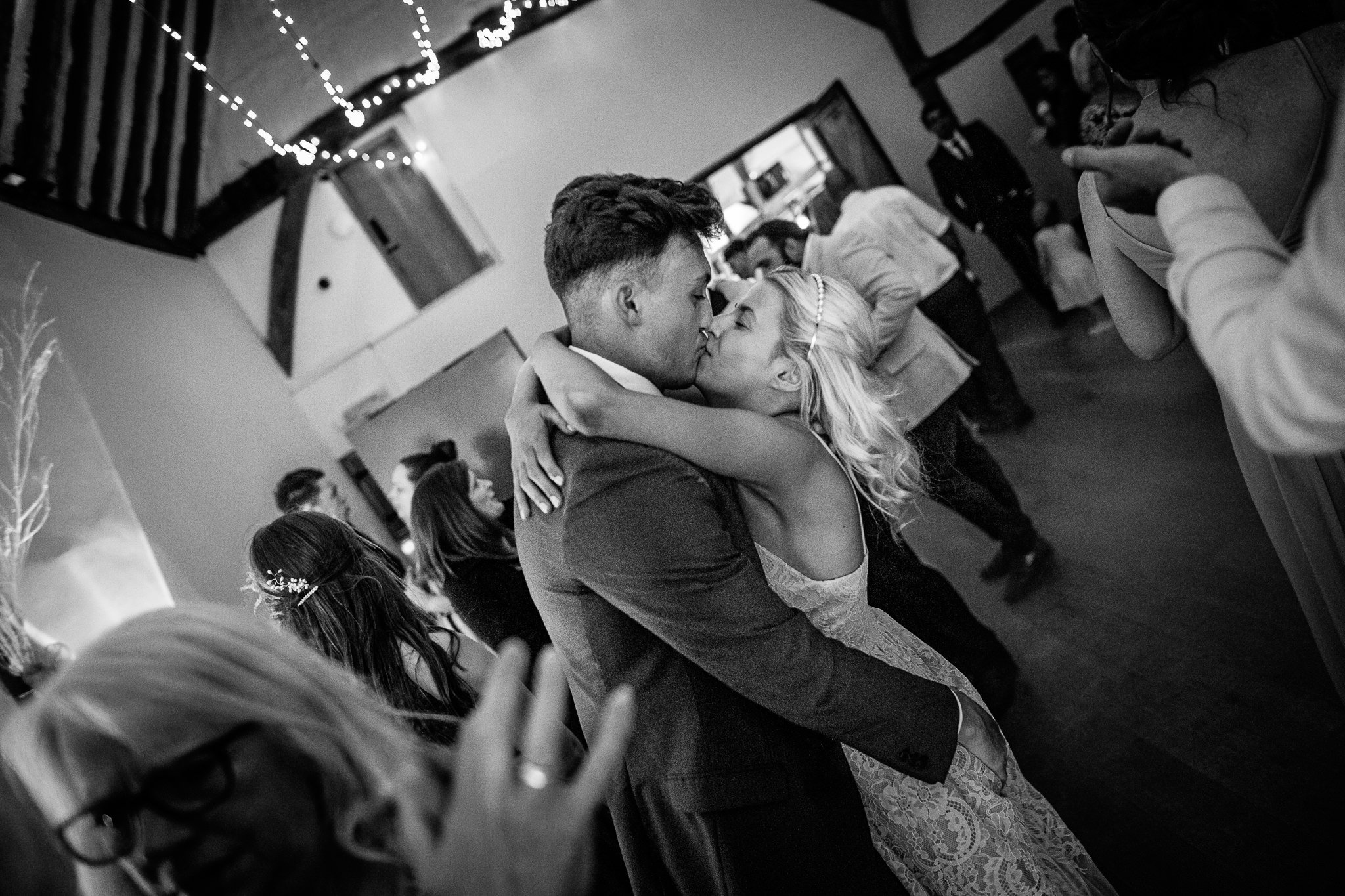  wedding guests kissing on the dance floor 
